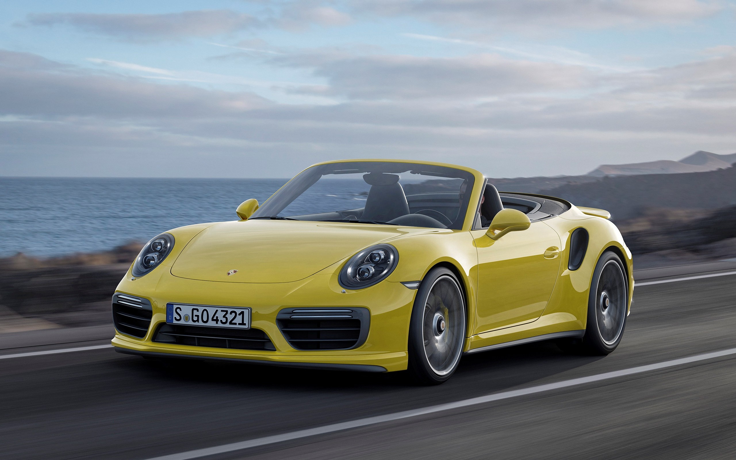 Yellow Porsche 911 Turbo Convertible driving on a road HD Wallpaper