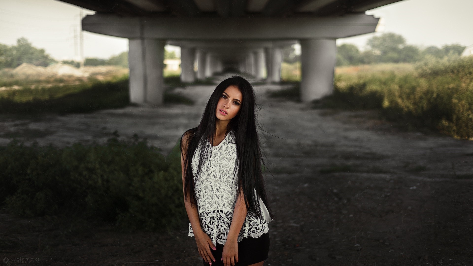 Woman in white top and black skirt under a bridge HD Wallpaper