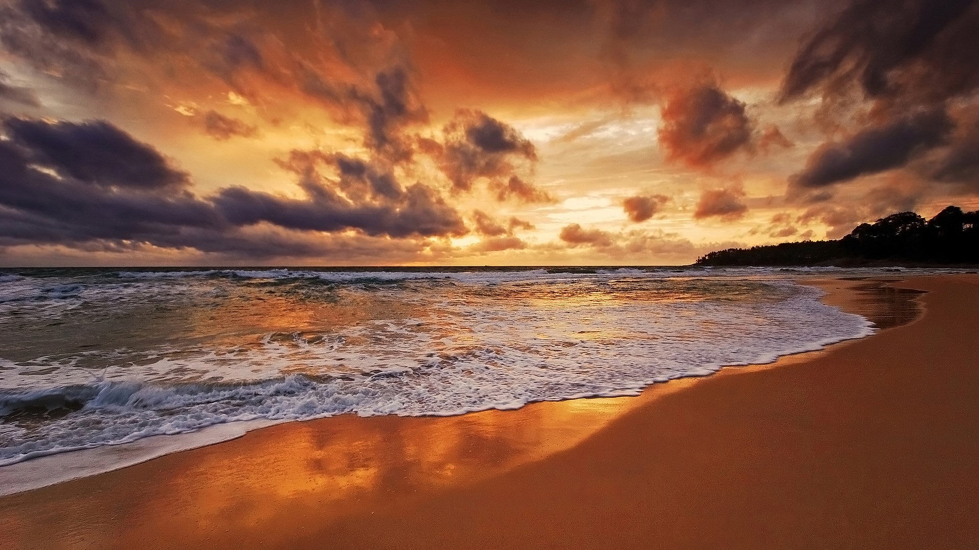 Sunset over a beach with dramatic clouds HD Wallpaper
