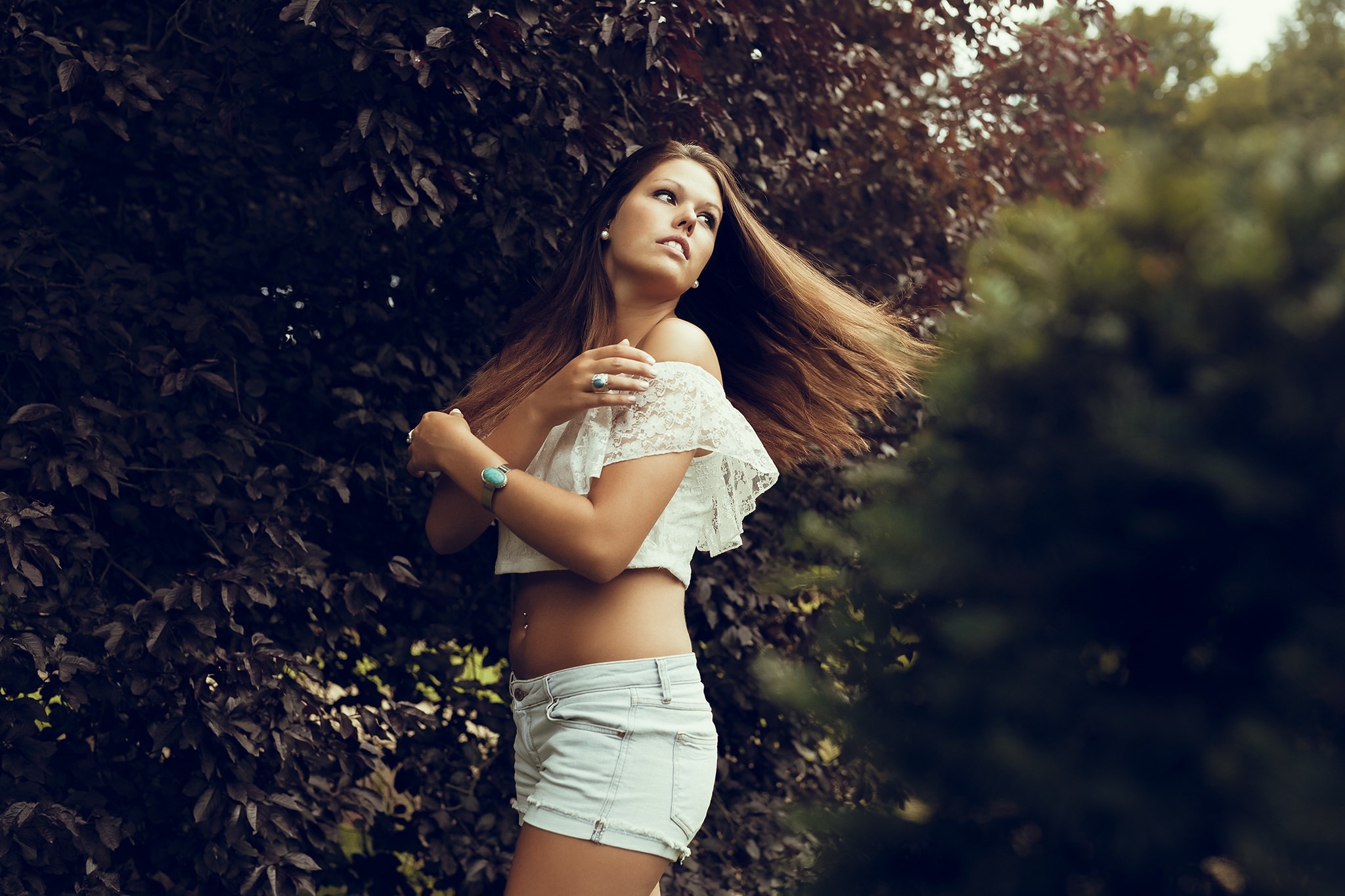 Woman with long brown hair in a white crop top and denim shorts HD Wallpaper