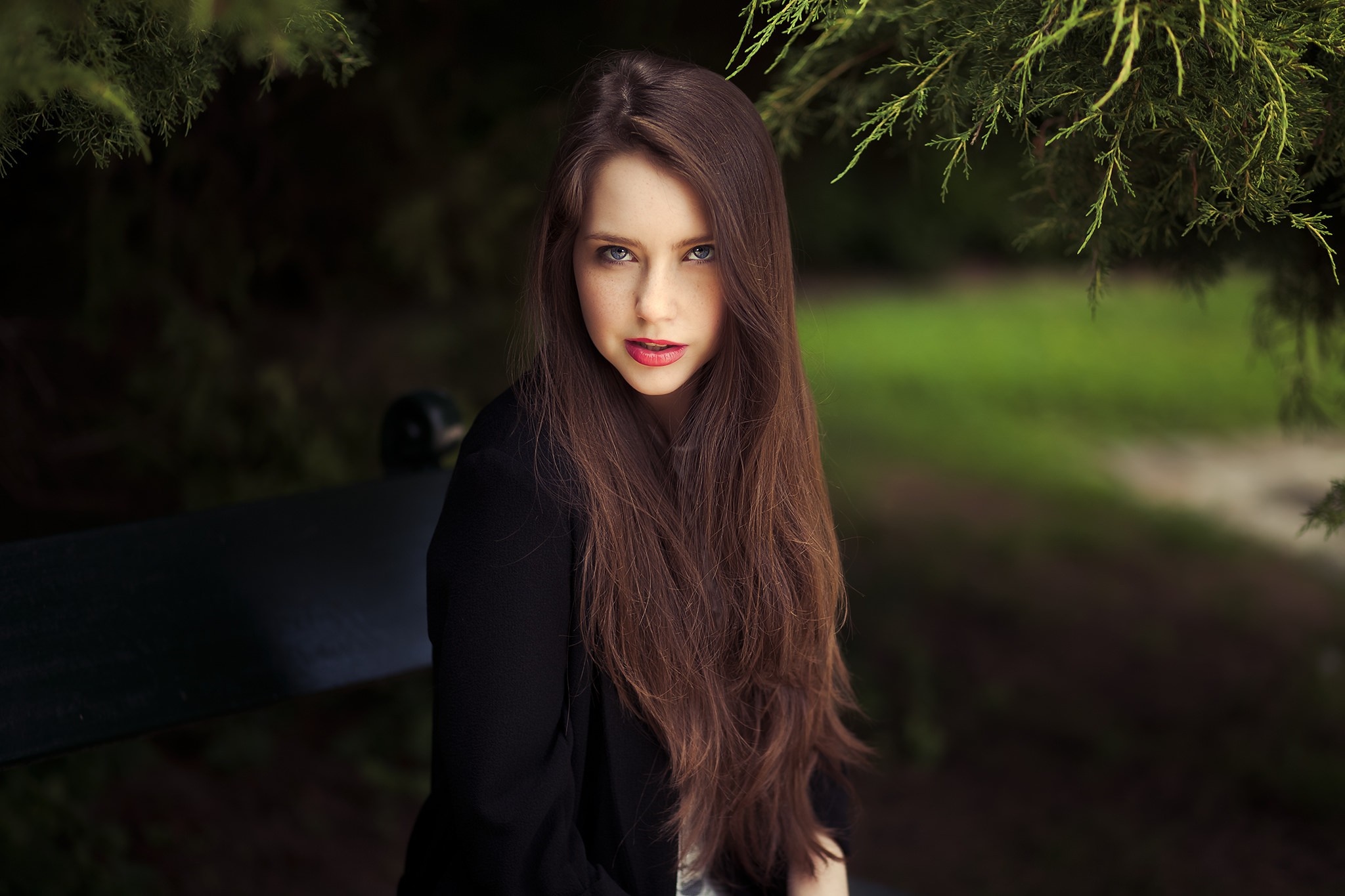 Woman with long brown hair sitting on a bench HD Wallpaper