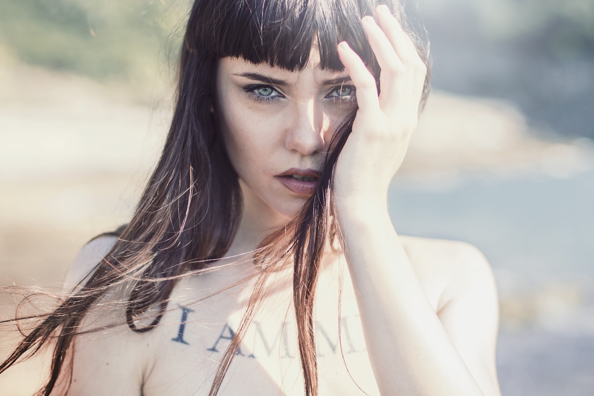 Woman with hand over face and tattoo HD Wallpaper
