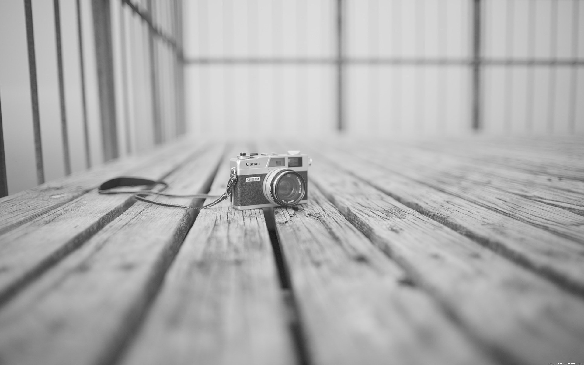 Canon camera on a wooden surface HD Wallpaper
