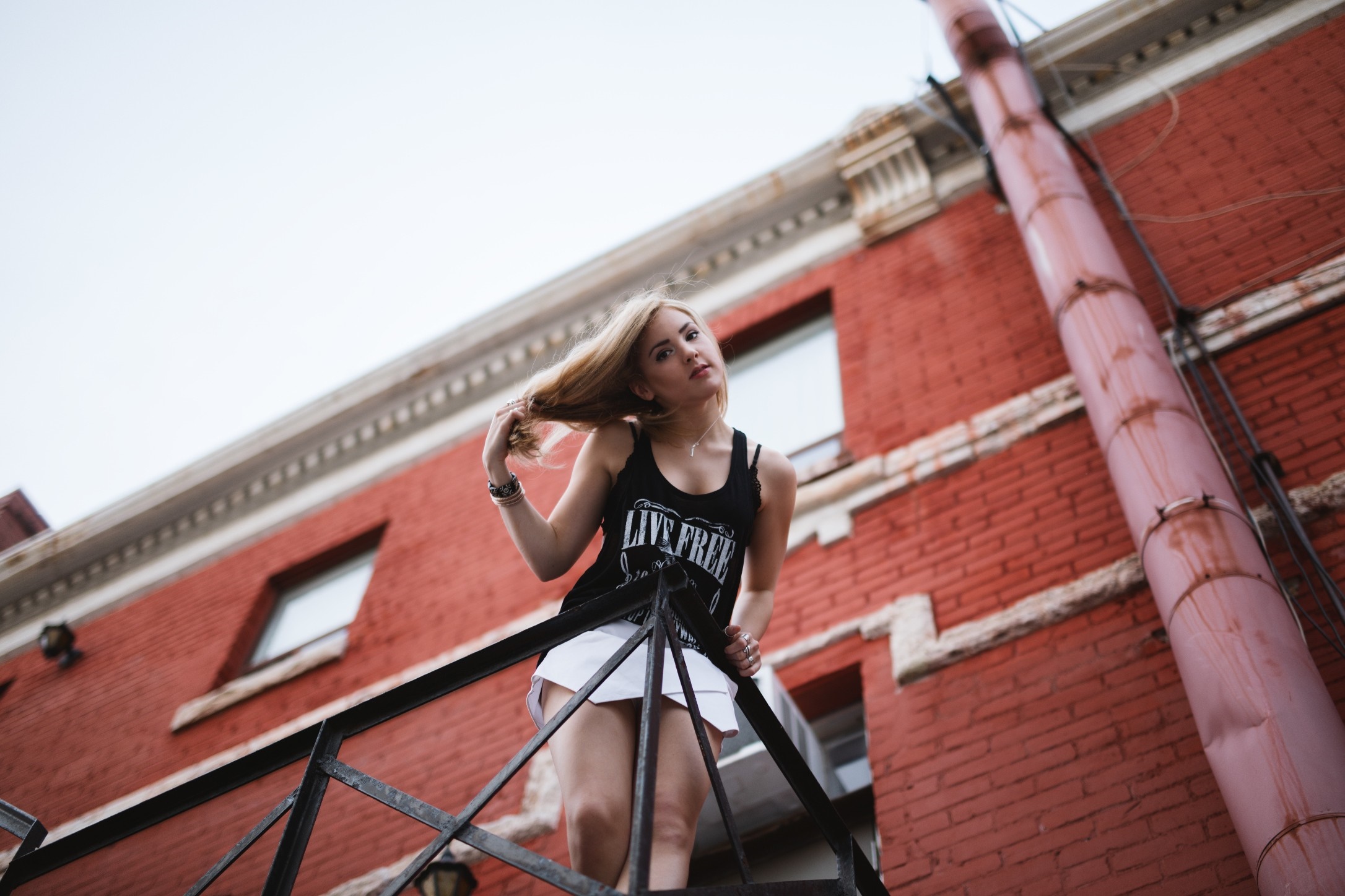 Woman on a fire escape HD Wallpaper