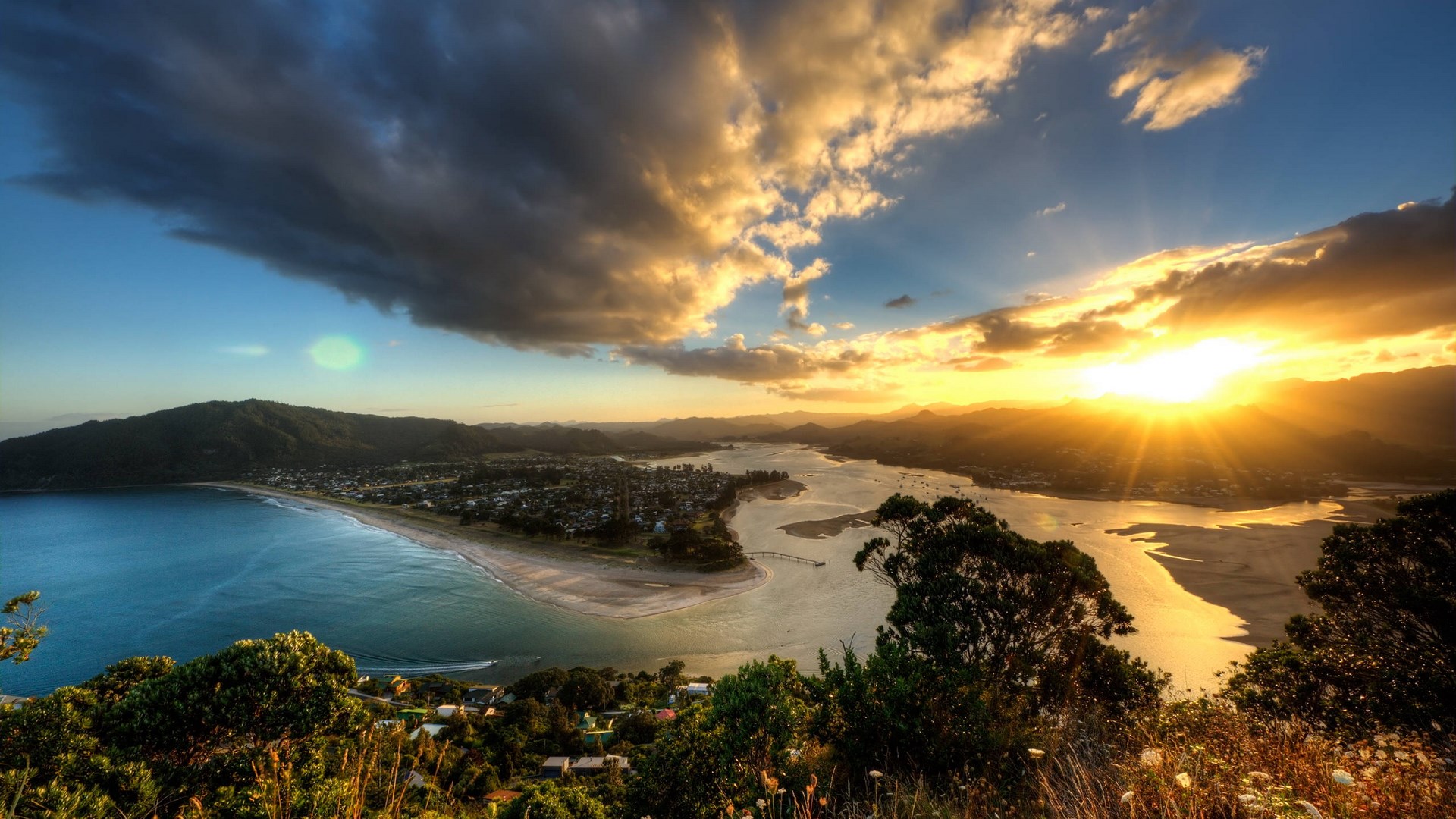 Sunset over a coastal town and bay HD Wallpaper