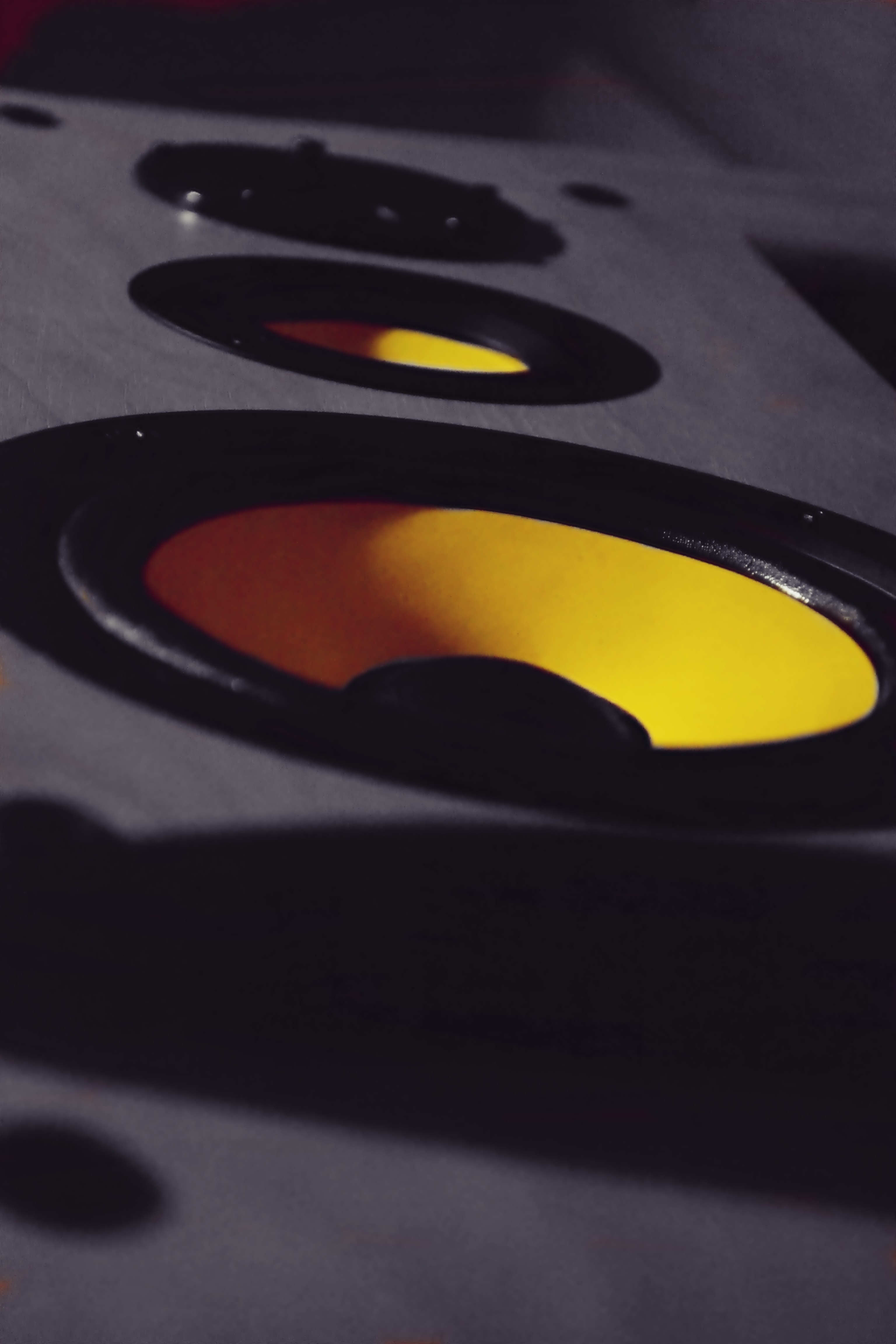 Close-up of yellow speaker cones in a car HD Wallpaper