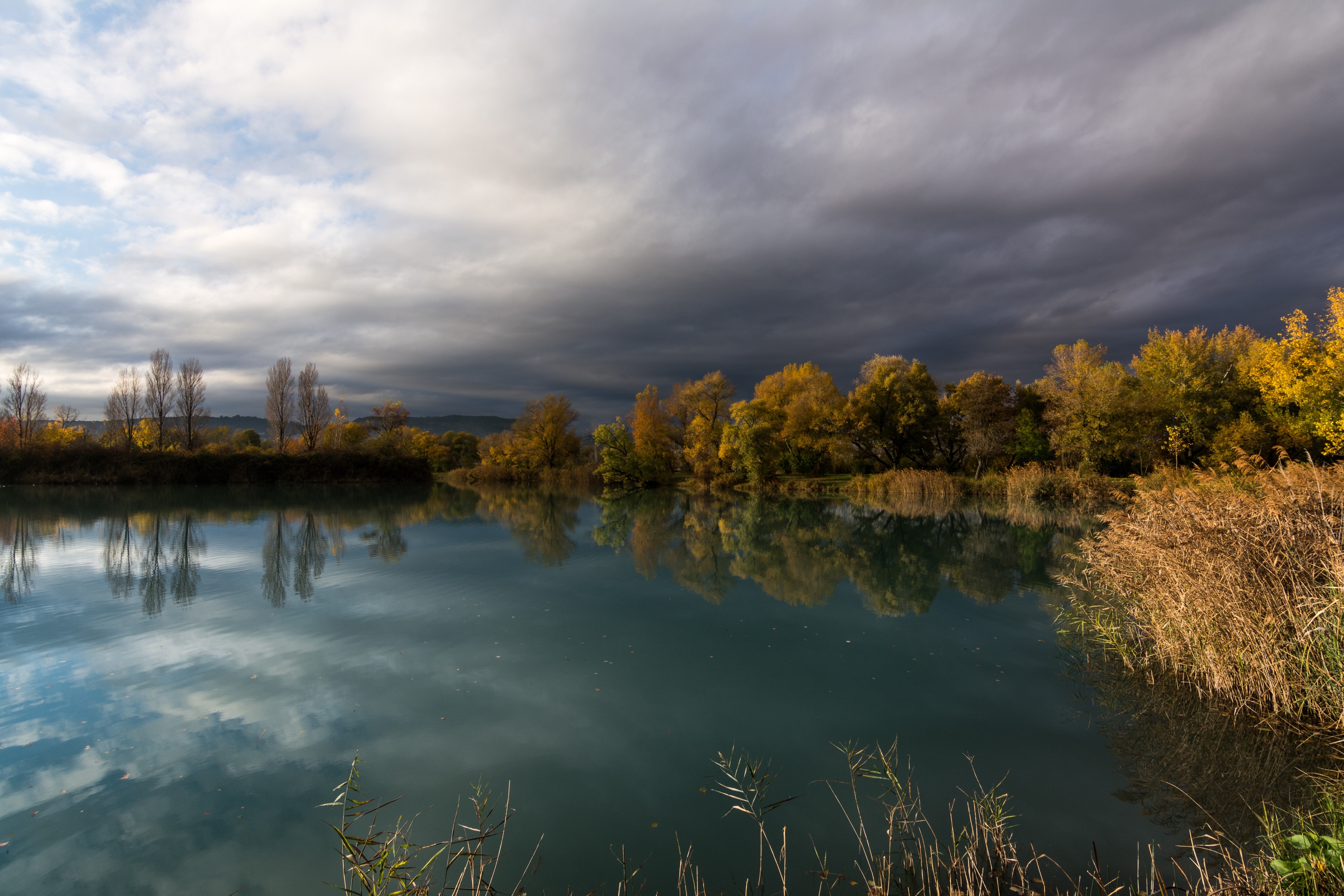 Autumn lake with trees and dramatic clouds HD Wallpaper
