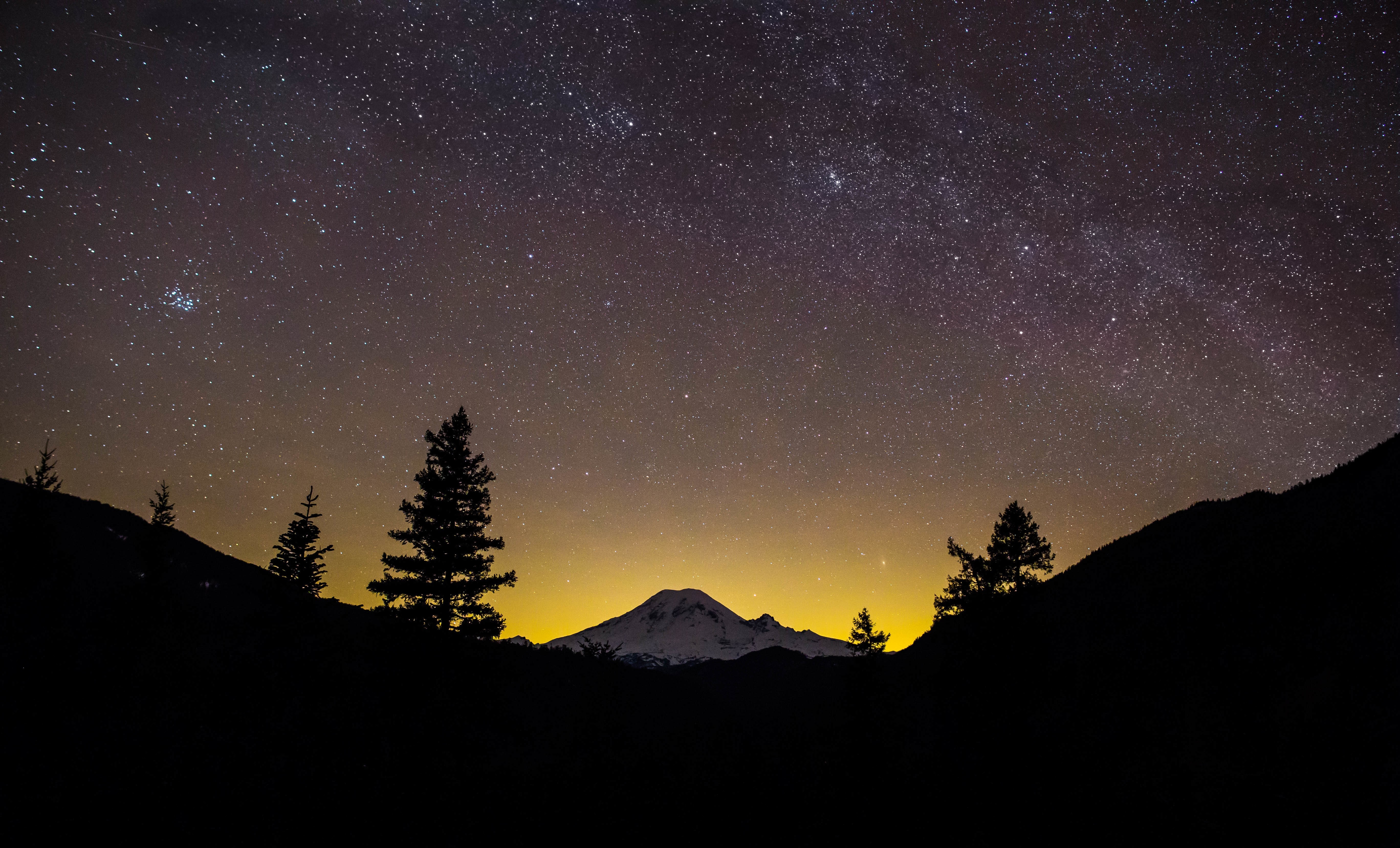 Mountain peak under a starry night sky HD Wallpaper