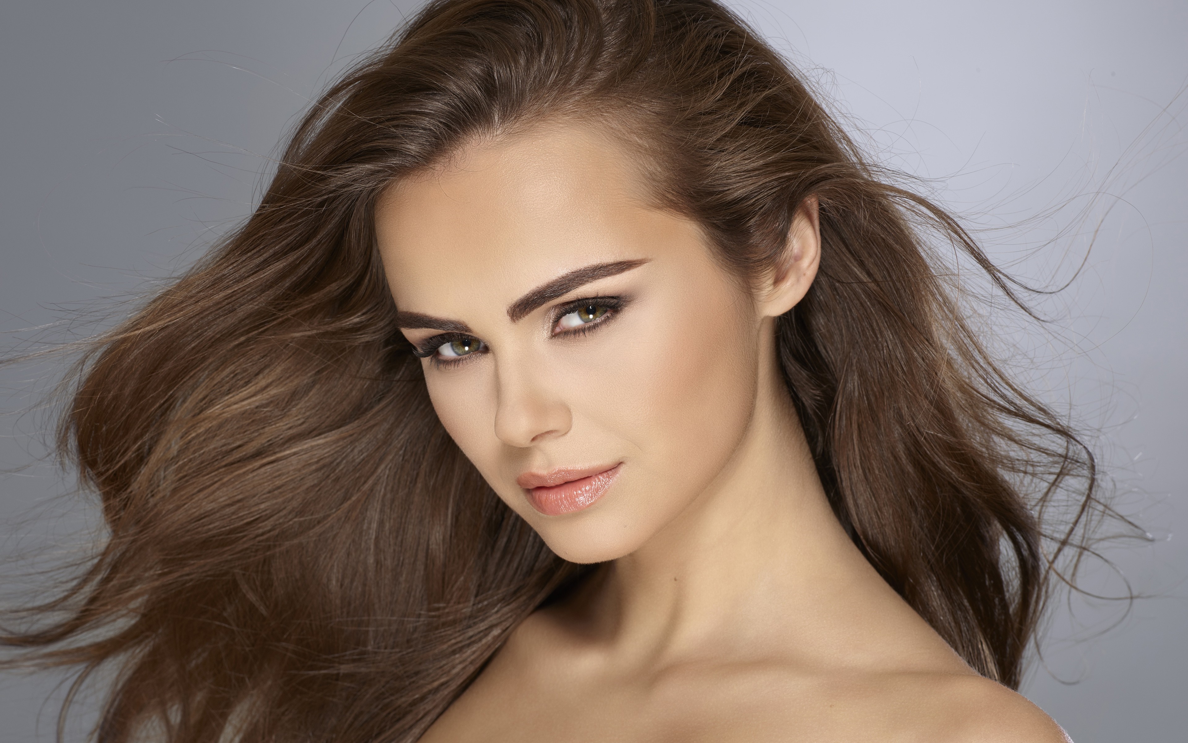 Close-up Portrait of a Brunette Woman with Flowing Hair HD Wallpaper
