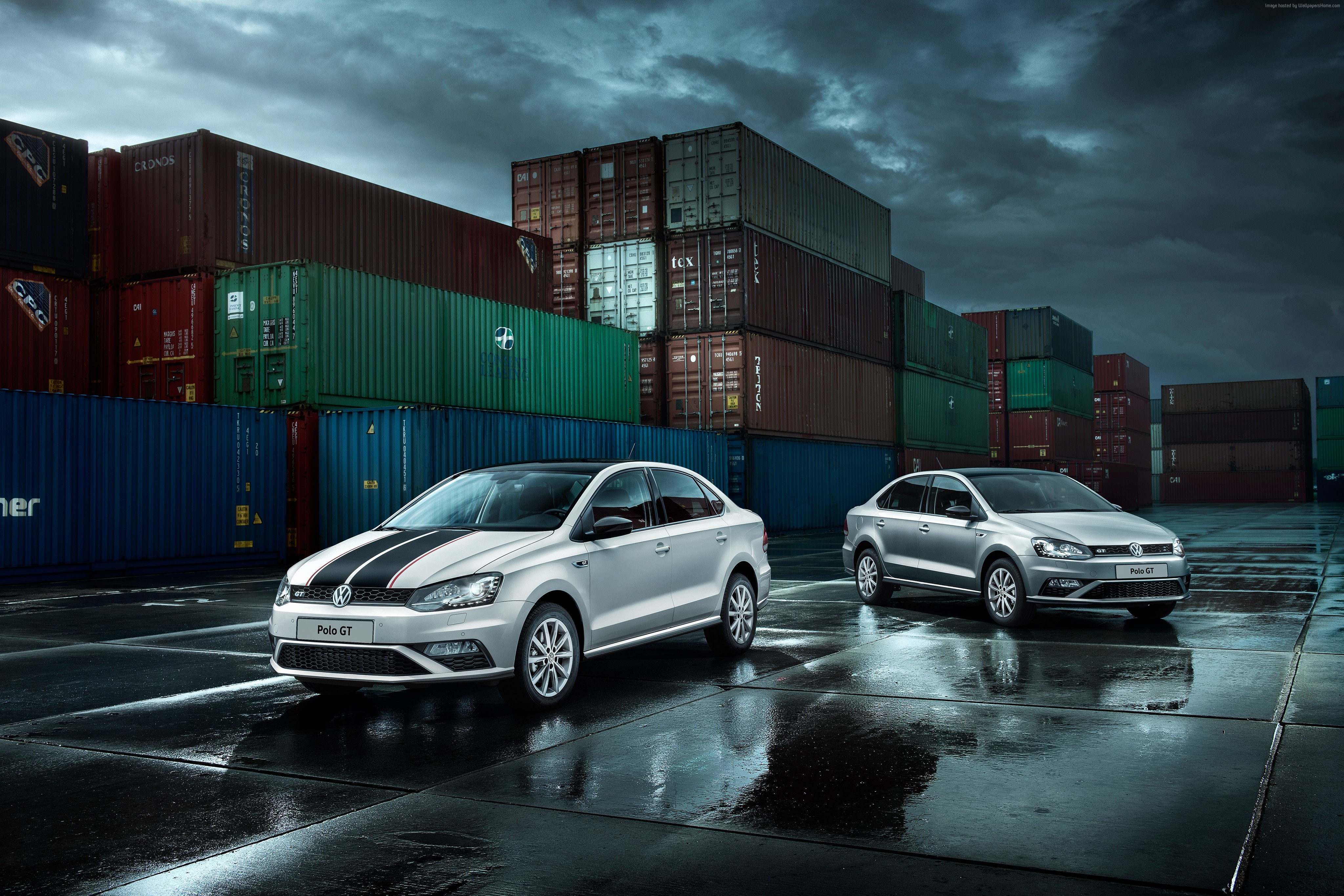 Two Volkswagen Polo Sedan GT cars in a shipping yard HD Wallpaper