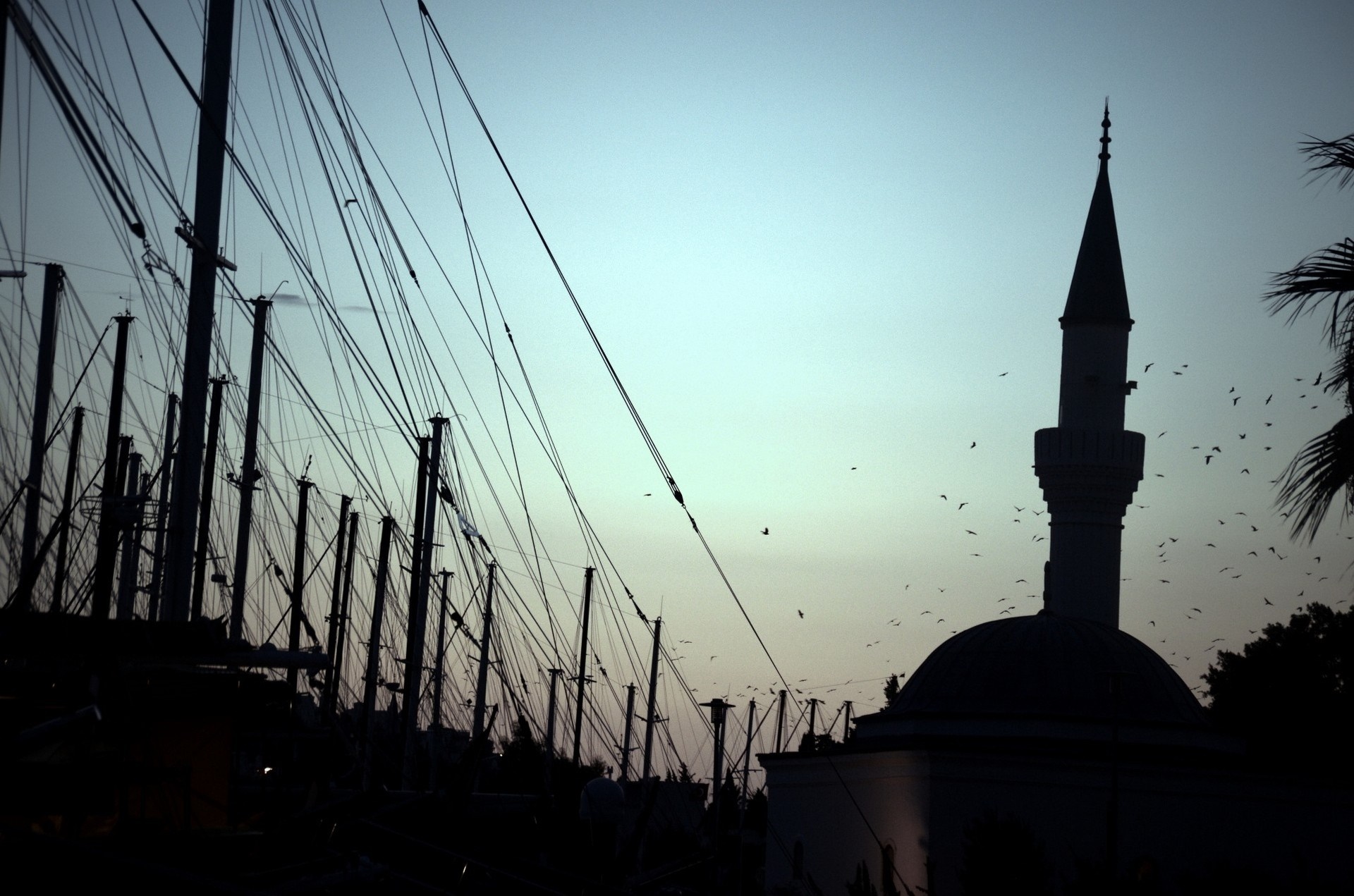 Mosque minaret and boats masts at dusk HD Wallpaper