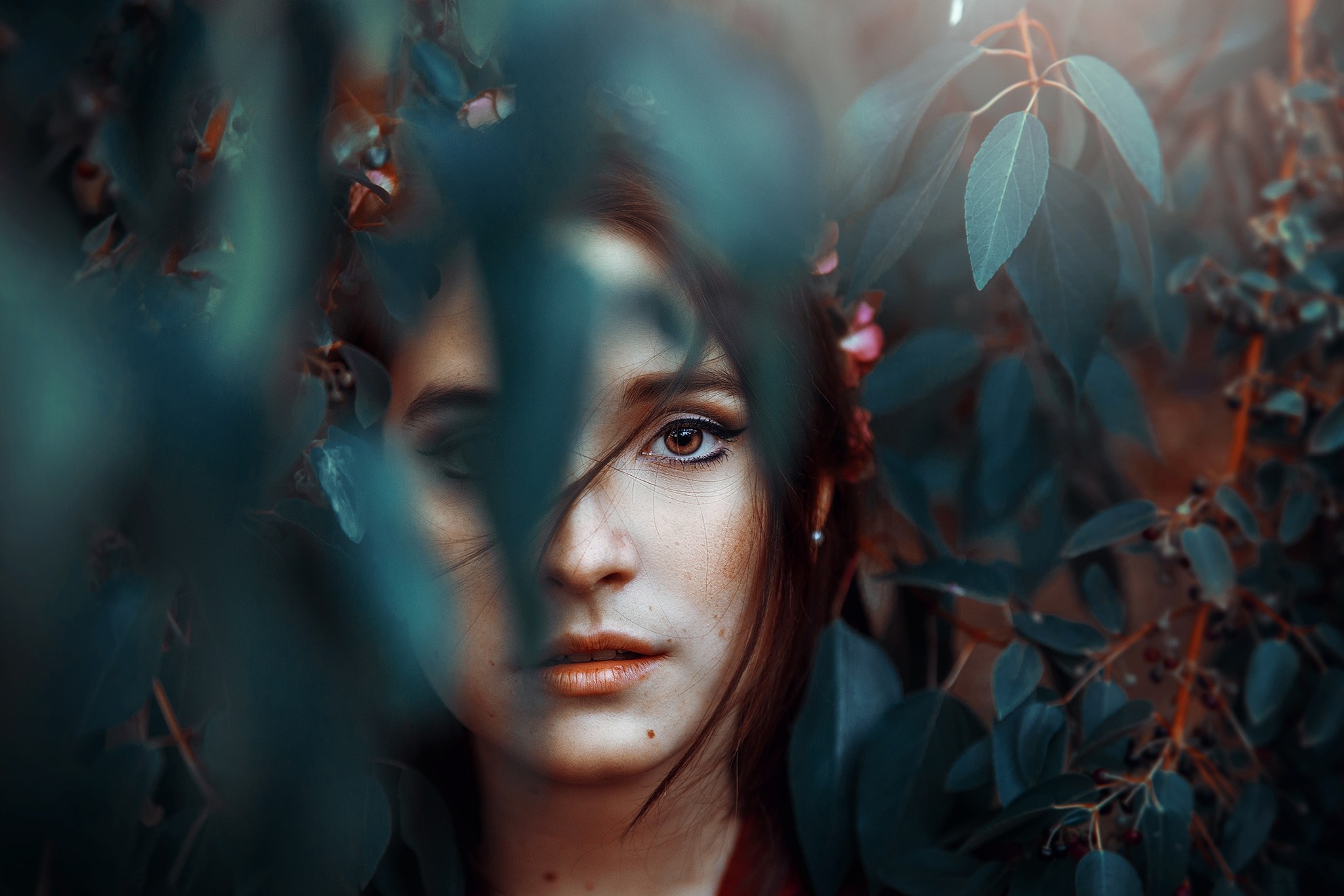 Woman partially hidden by leaves HD Wallpaper