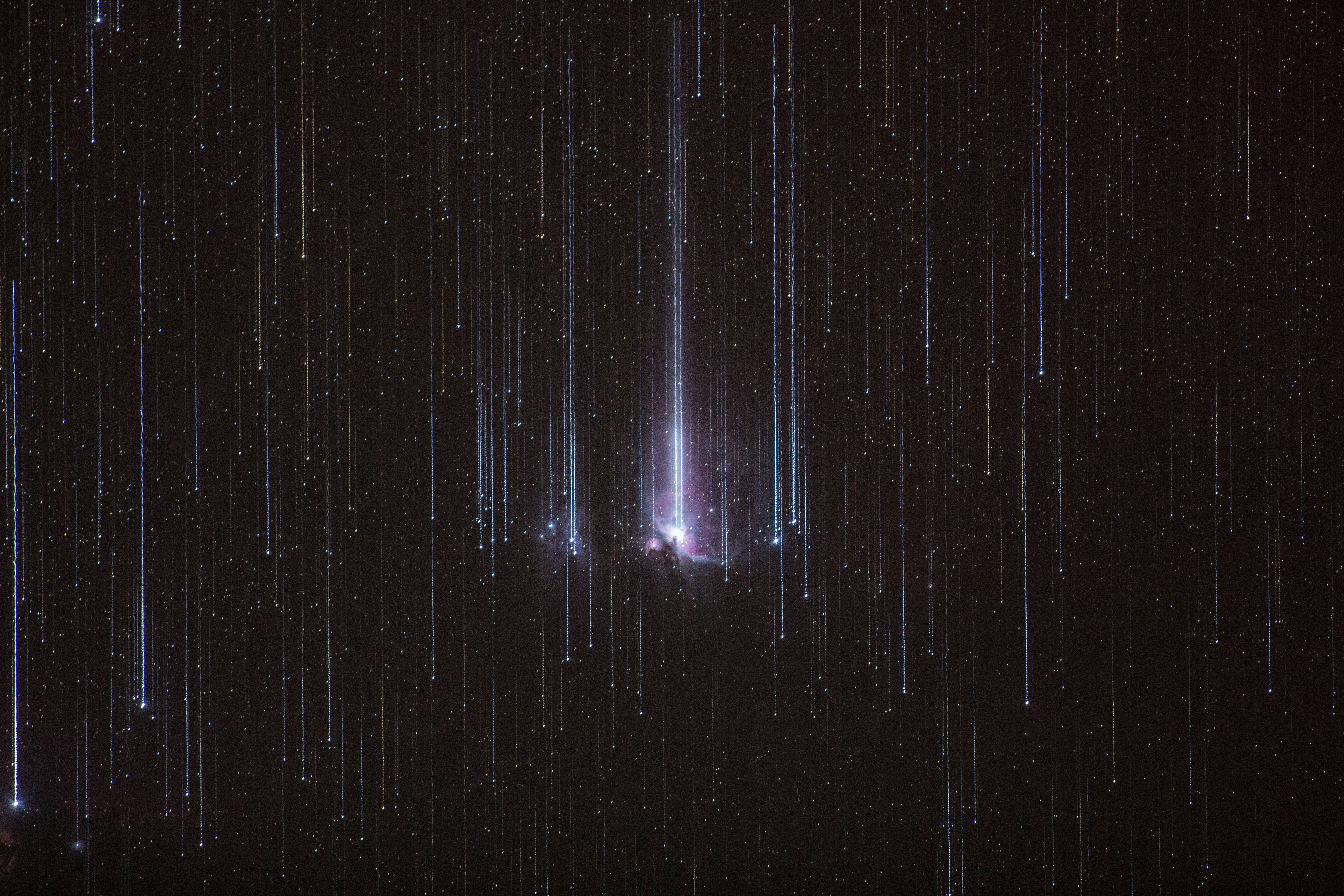 Meteor shower over the Orion Nebula HD Wallpaper