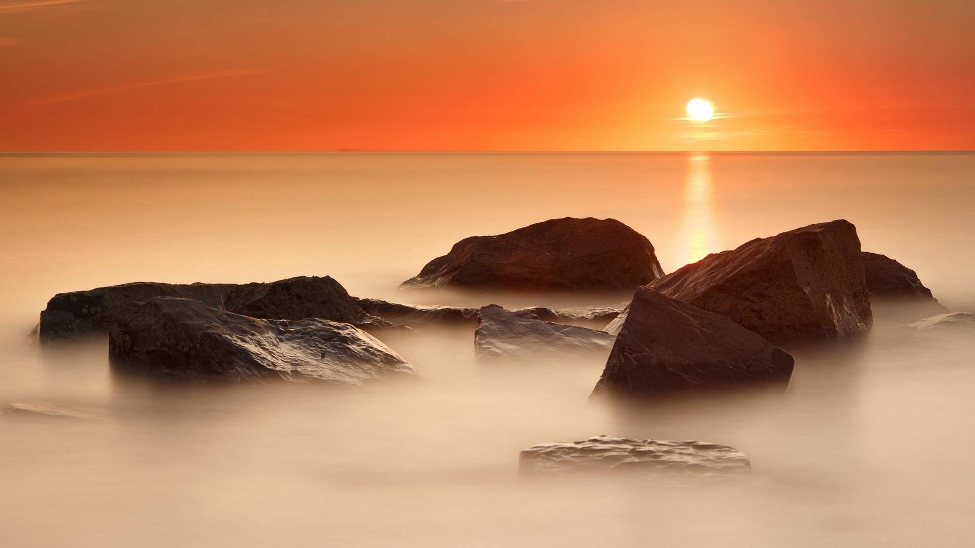 Sunset over the sea with rocks HD Wallpaper
