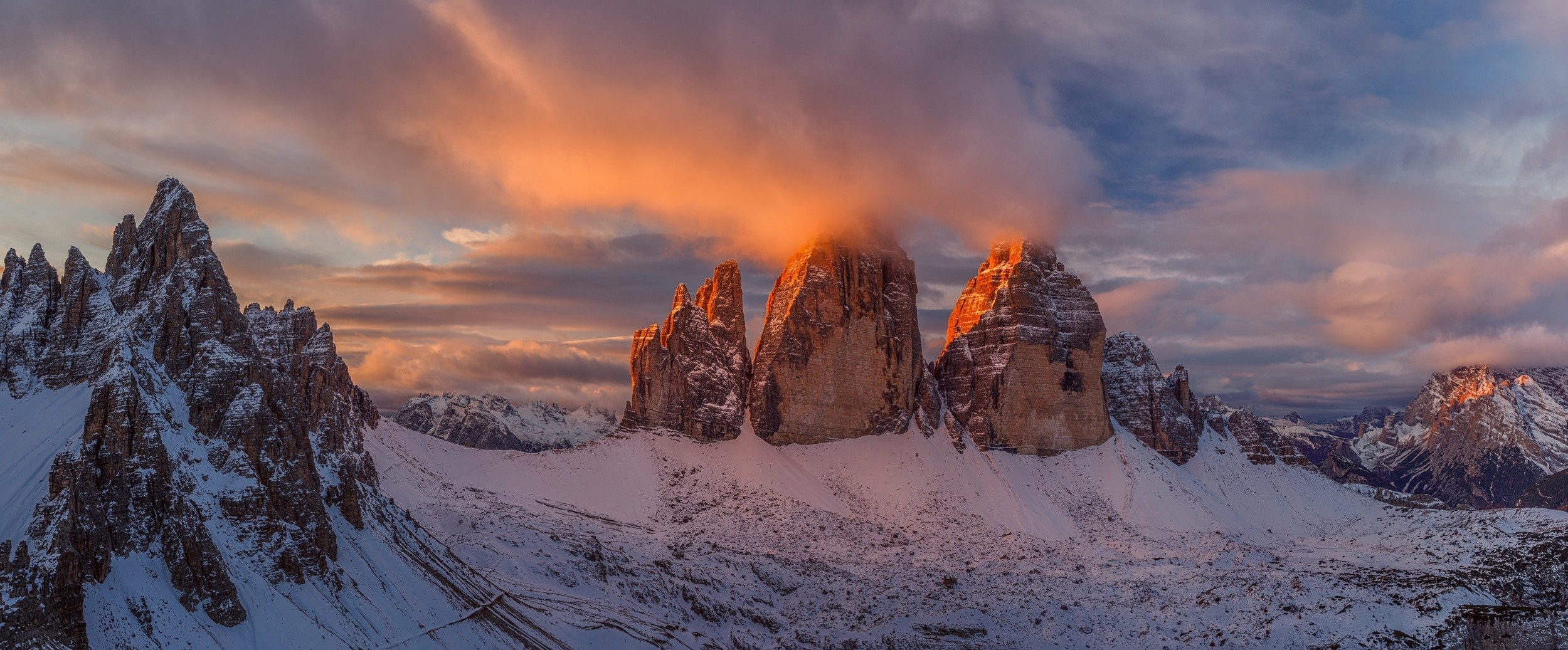 Tre Cime di Lavaredo mountains at sunset in winter HD Wallpaper