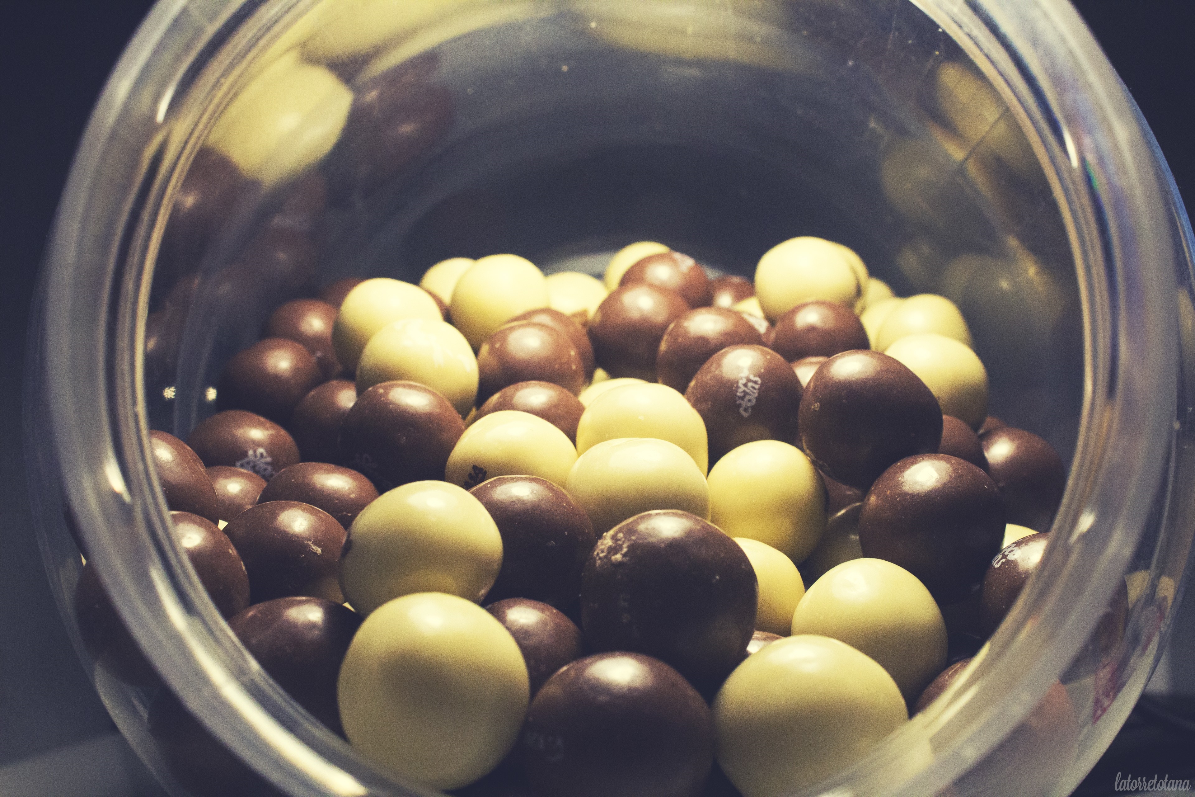 Chocolate balls in a clear container HD Wallpaper