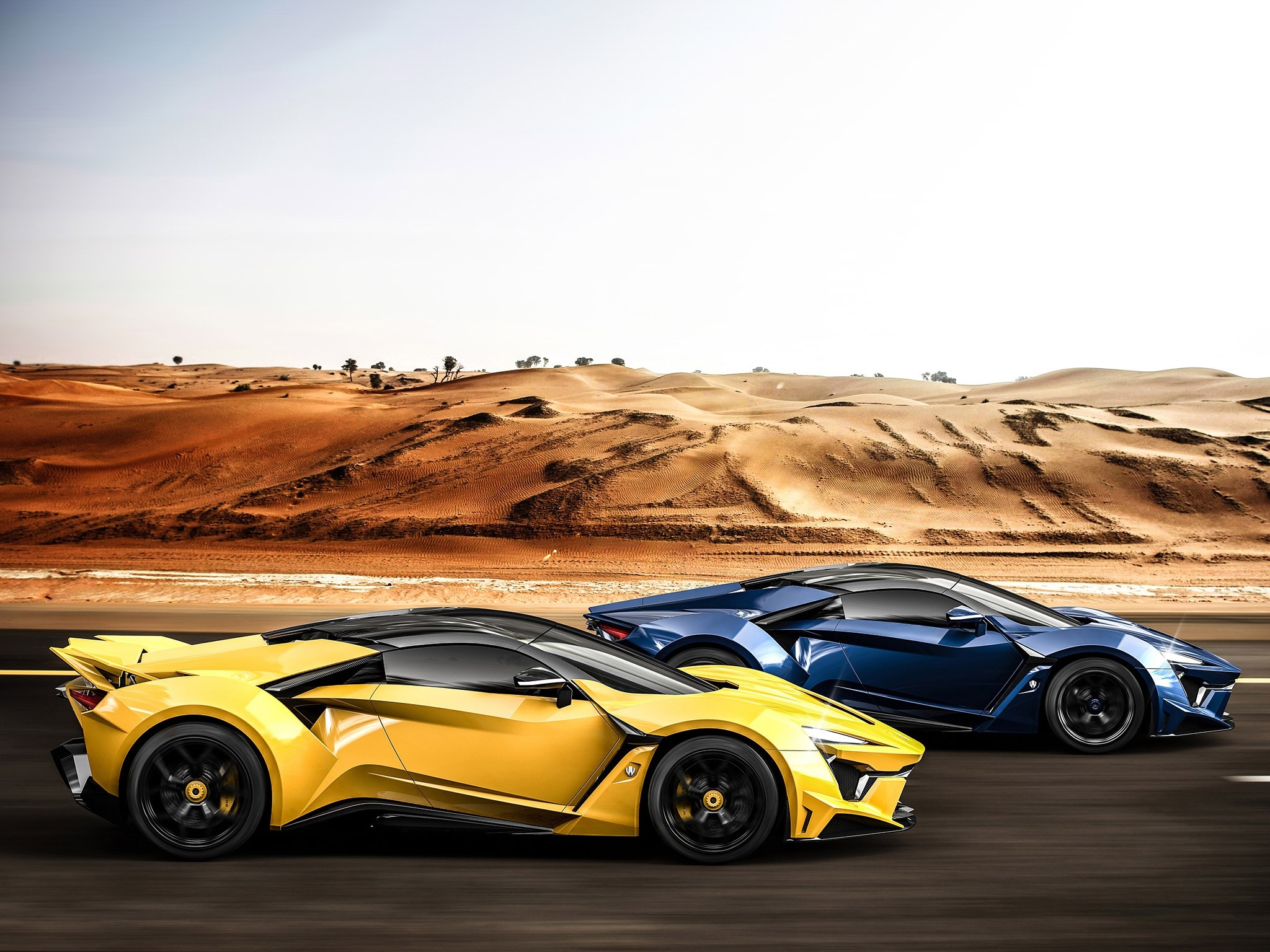 Yellow and blue sports cars driving on a desert road HD Wallpaper