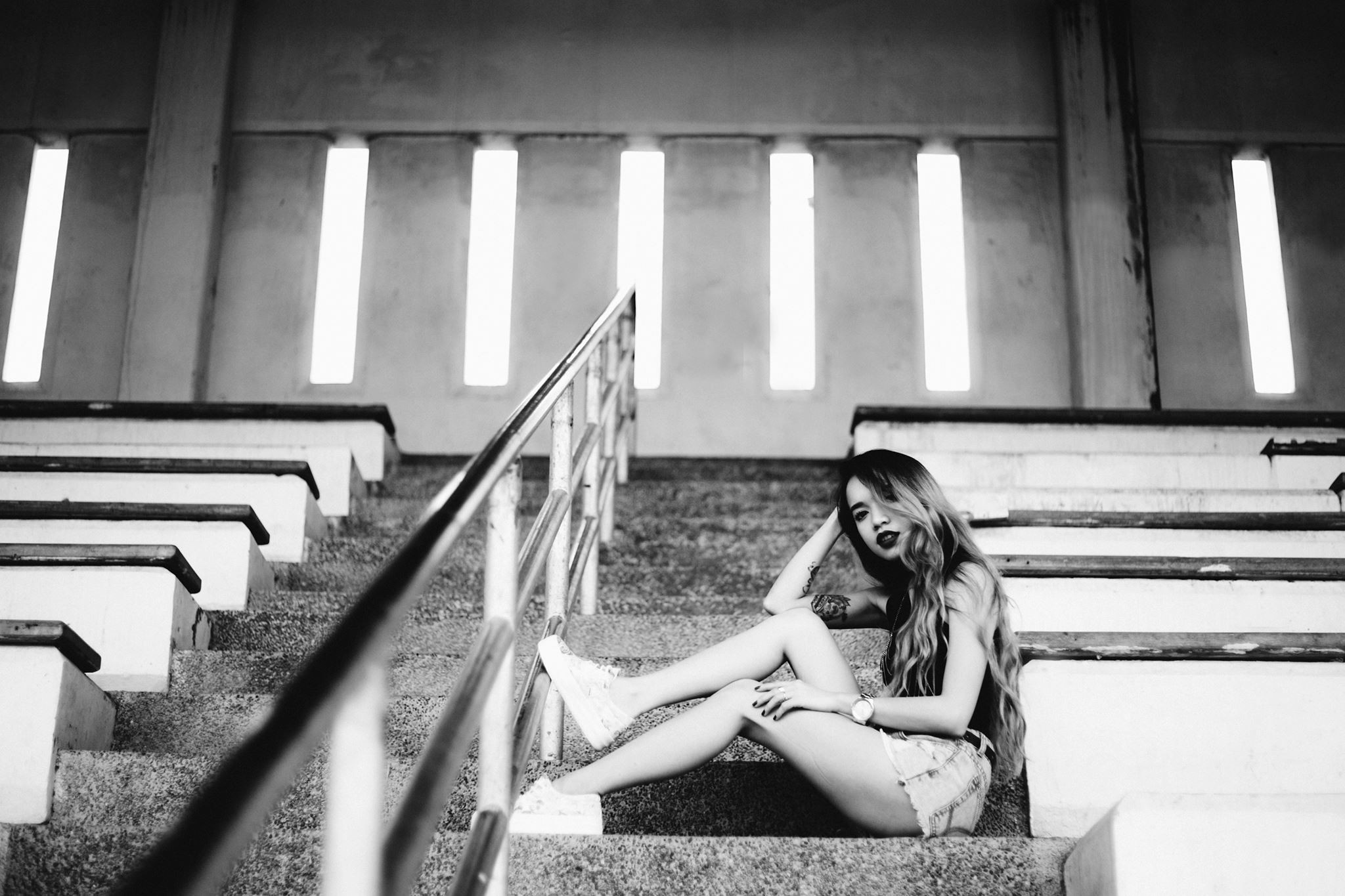 Woman sitting on stadium stairs HD Wallpaper