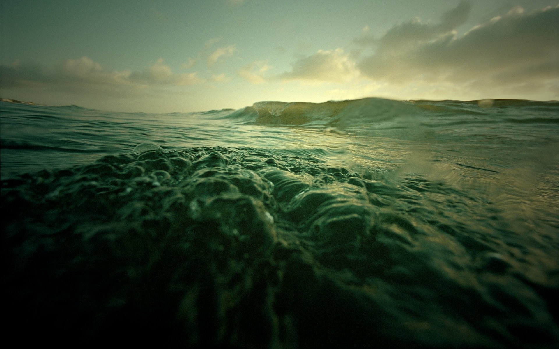 Ocean waves at sunset with clouds HD Wallpaper