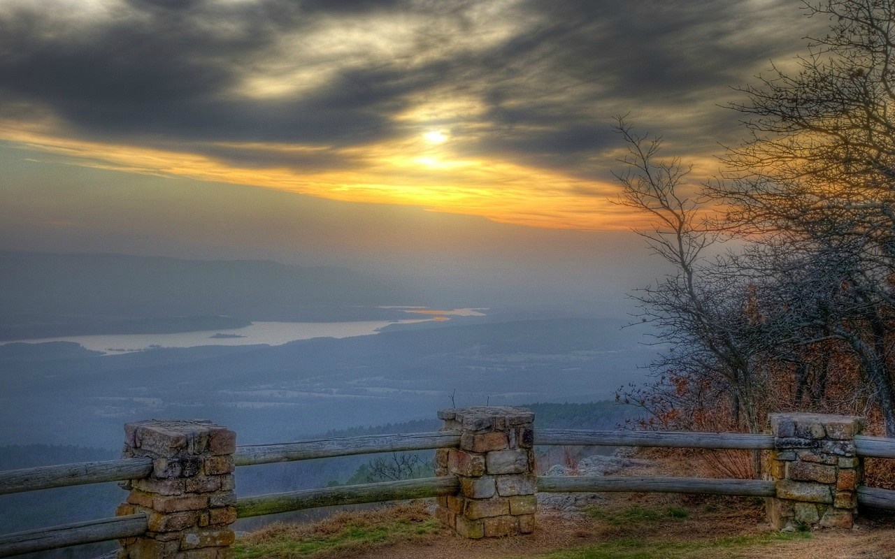 Sunset over a misty landscape with a wooden fence HD Wallpaper
