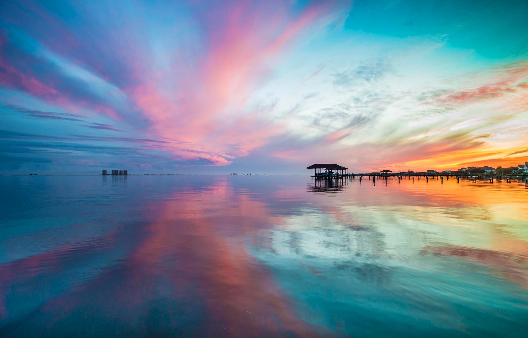 Sunset over the ocean with reflections and a pier HD Wallpaper