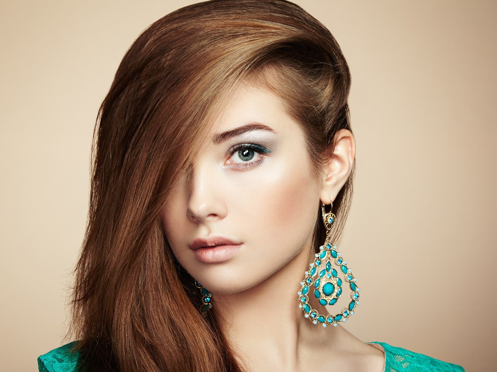 Woman with long brown hair and large turquoise earrings HD Wallpaper