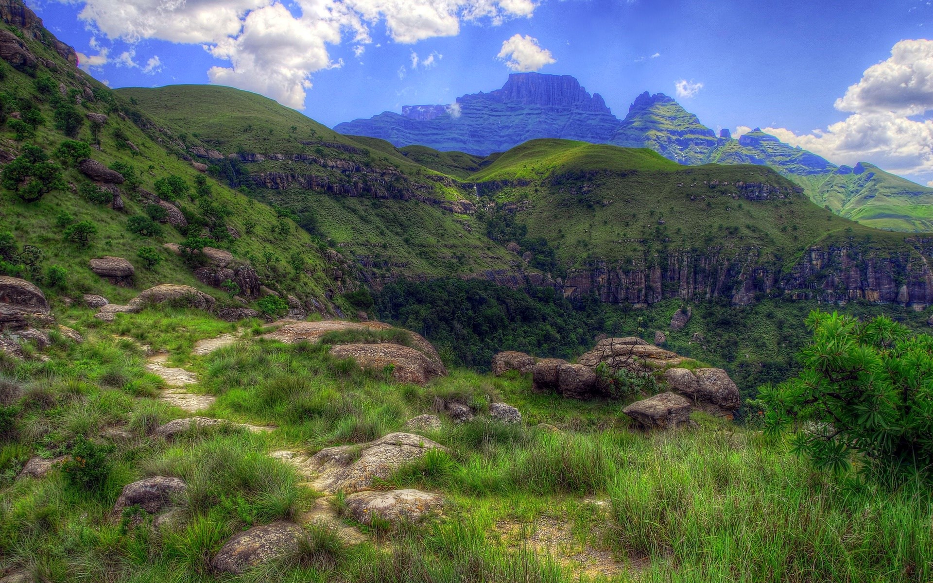 Green Mountains and Rocky Path Under Blue Sky HD Wallpaper