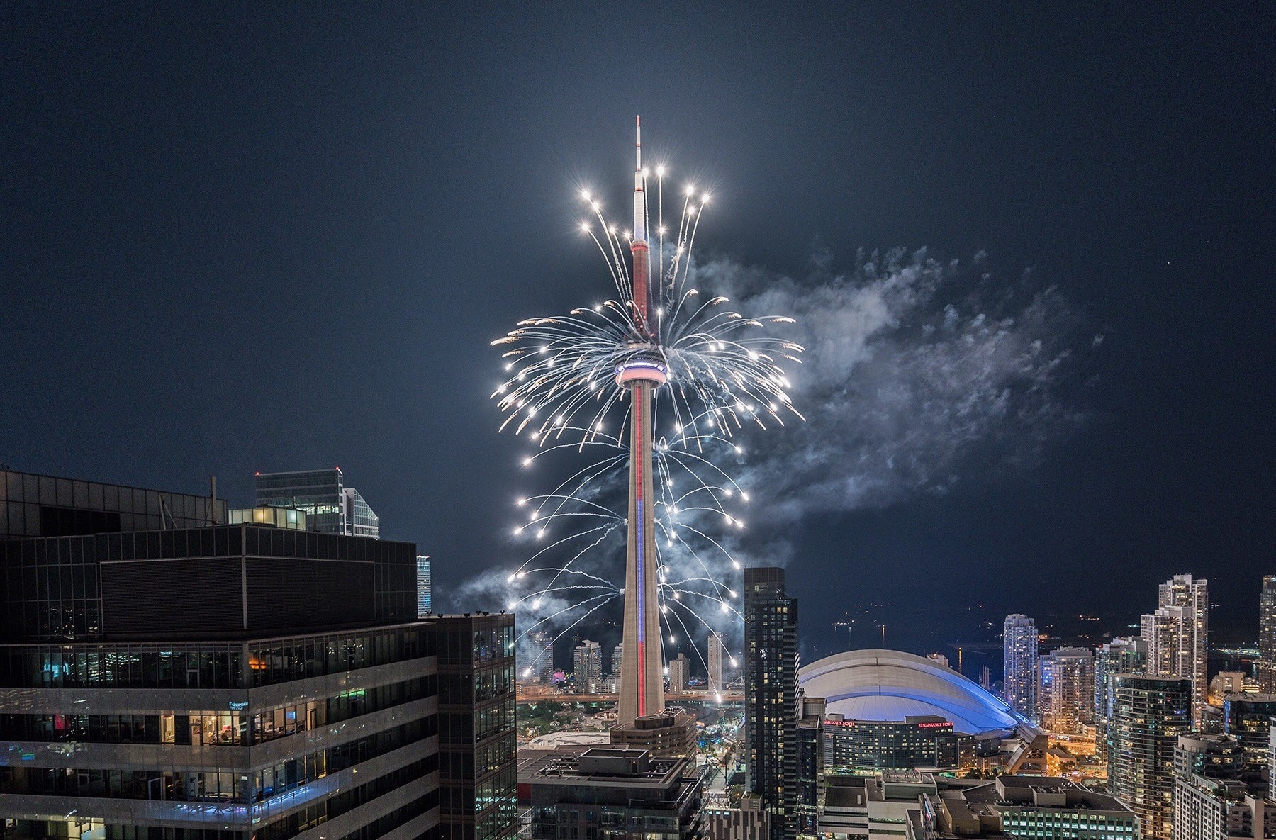 Fireworks over CN Tower in Toronto at night HD Wallpaper