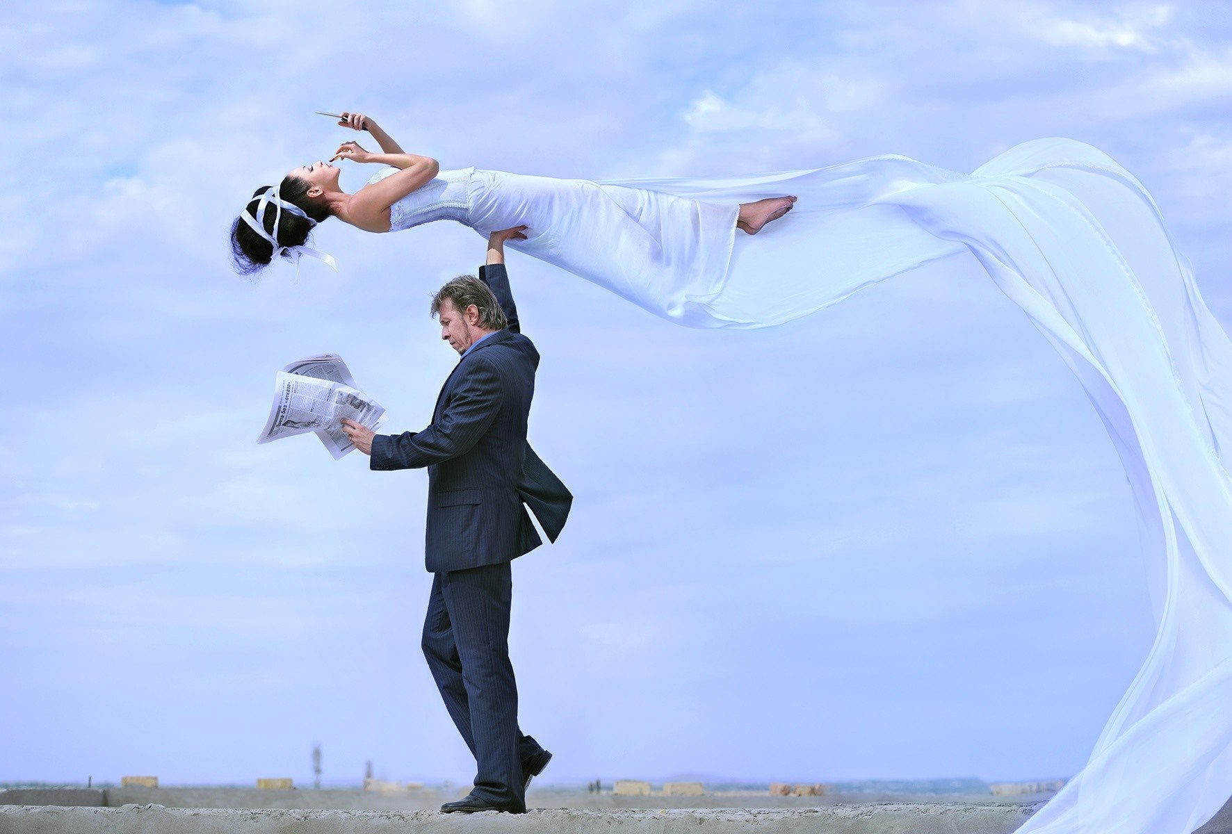 Man holding woman in white dress with flowing fabric HD Wallpaper