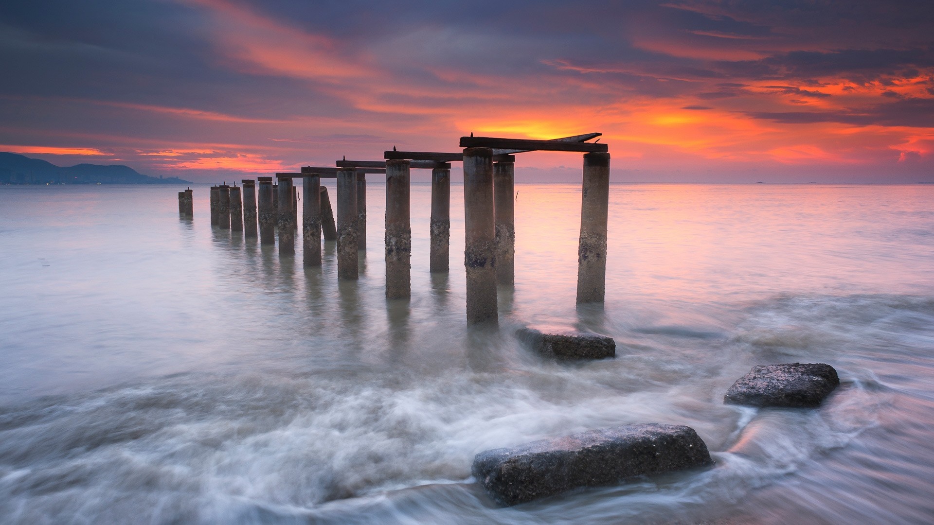 Old pier pilings in the ocean at sunset HD Wallpaper