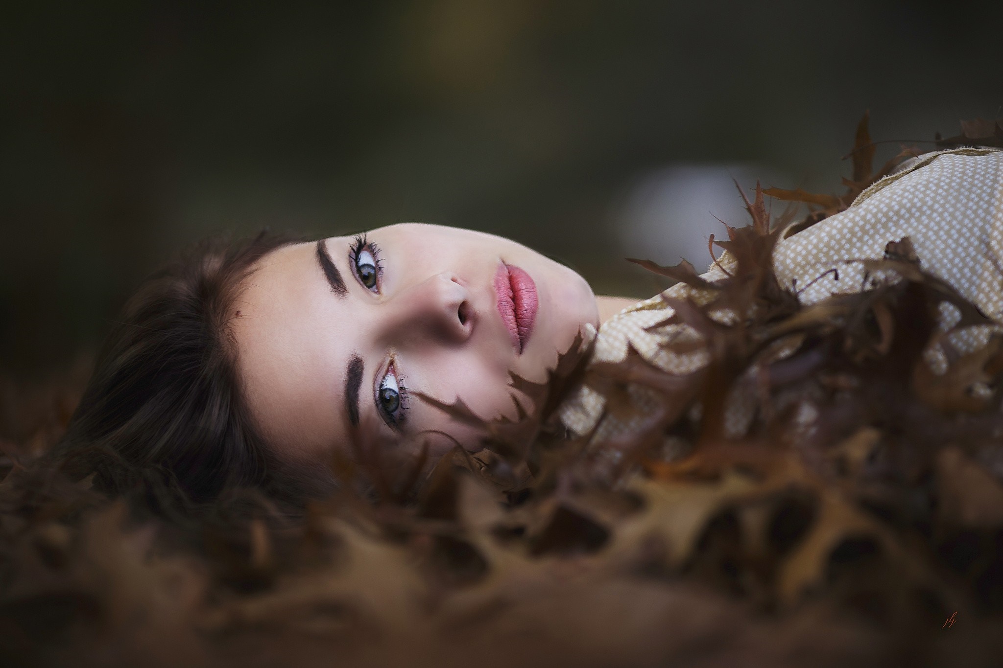 Woman lying in autumn leaves HD Wallpaper