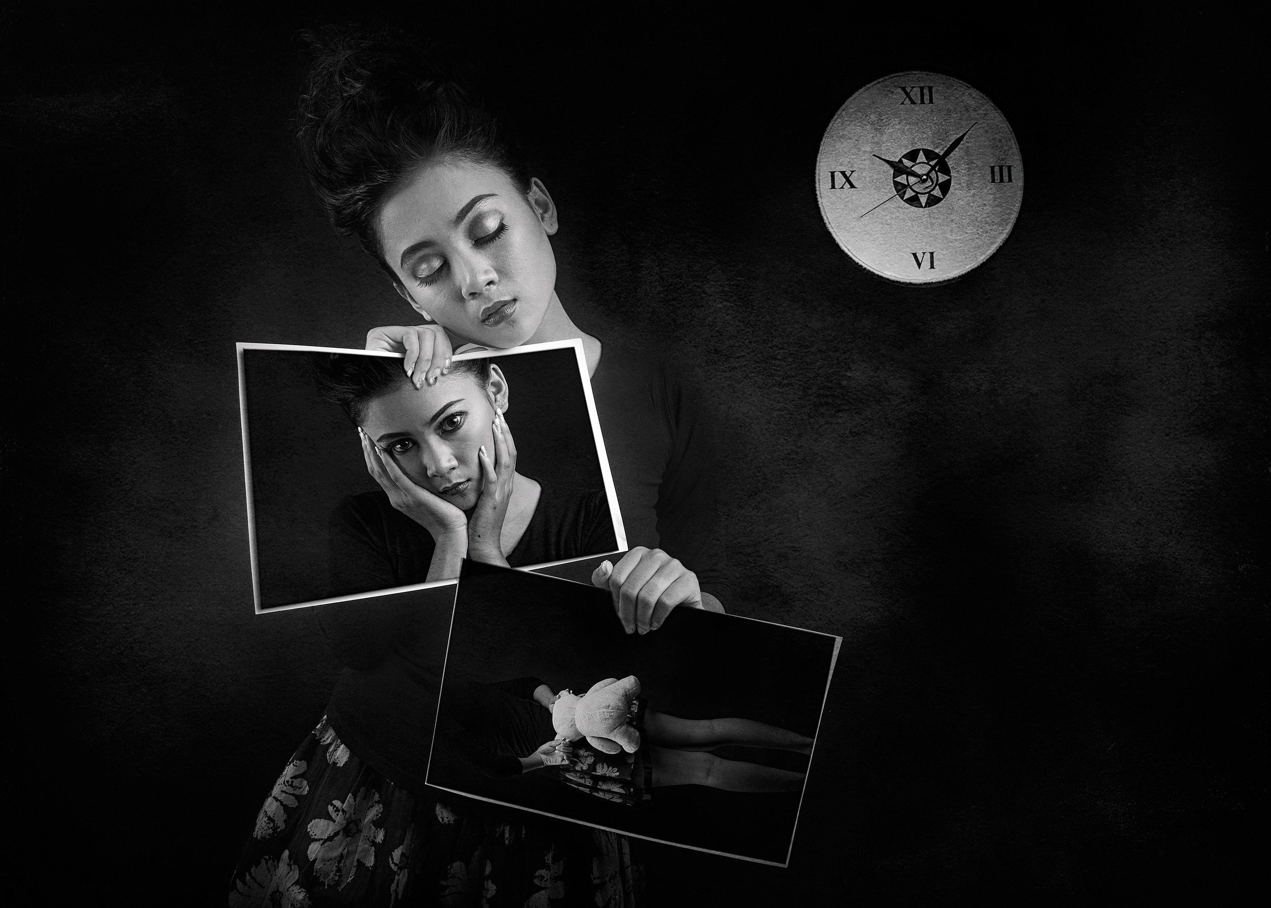 Woman holding portraits of herself and a doll HD Wallpaper