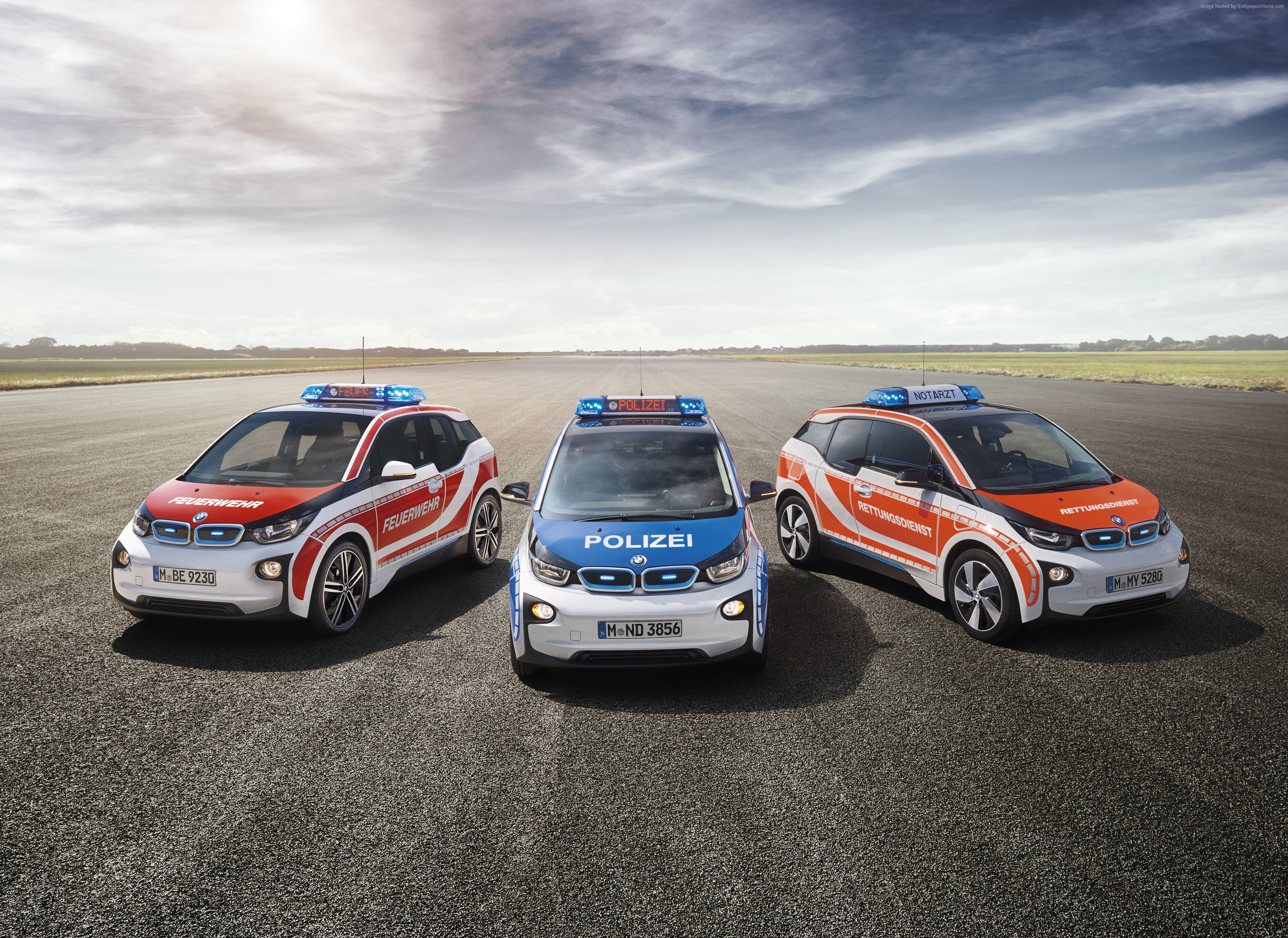 Three BMW i3 emergency vehicles on asphalt HD Wallpaper