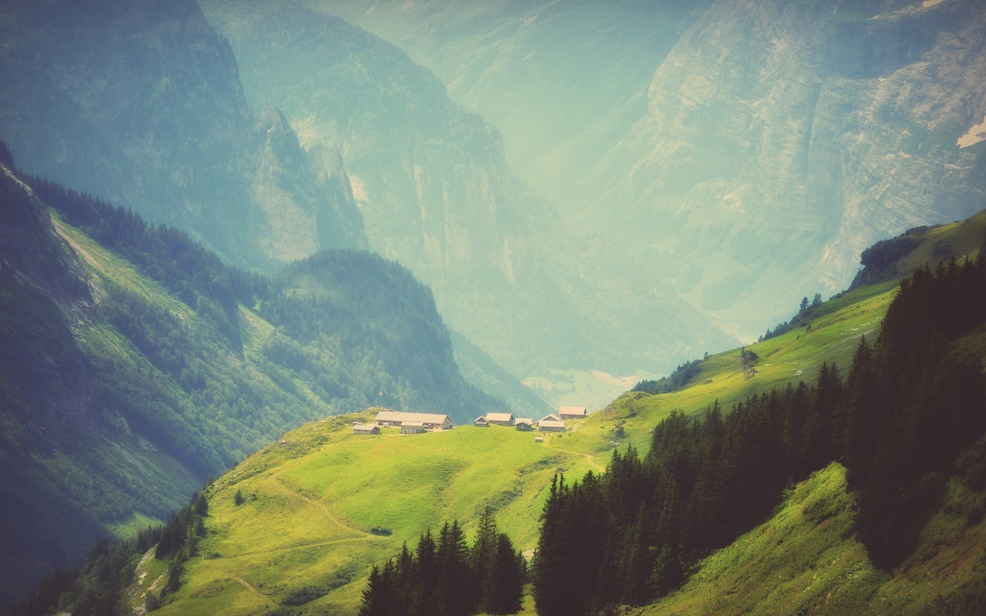 Alpine village nestled in a mountain valley HD Wallpaper