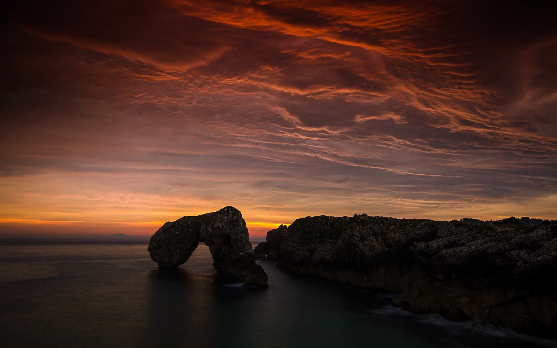 Arch rock formation at sunset over the sea HD Wallpaper