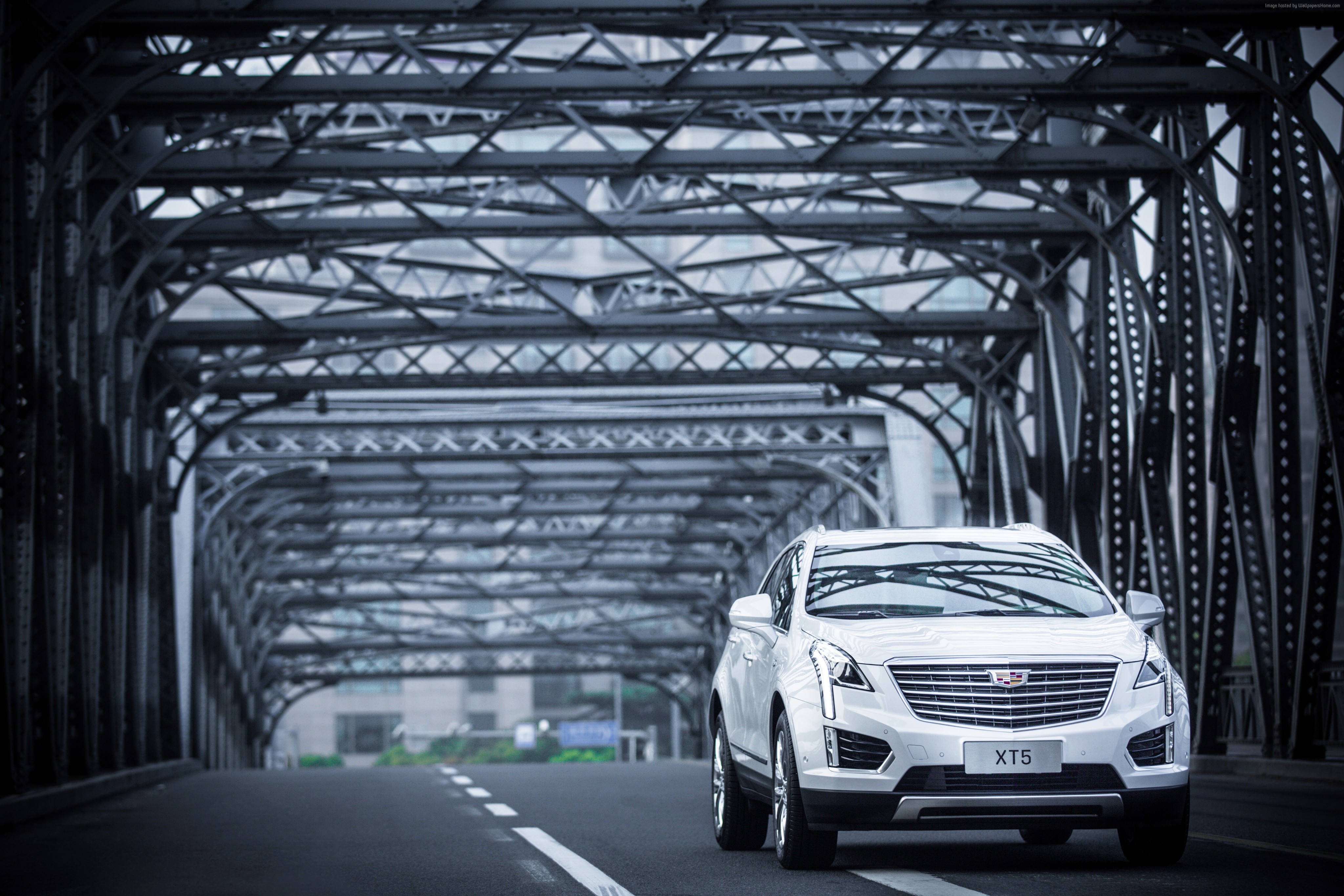 White Cadillac XT5 driving on a bridge HD Wallpaper