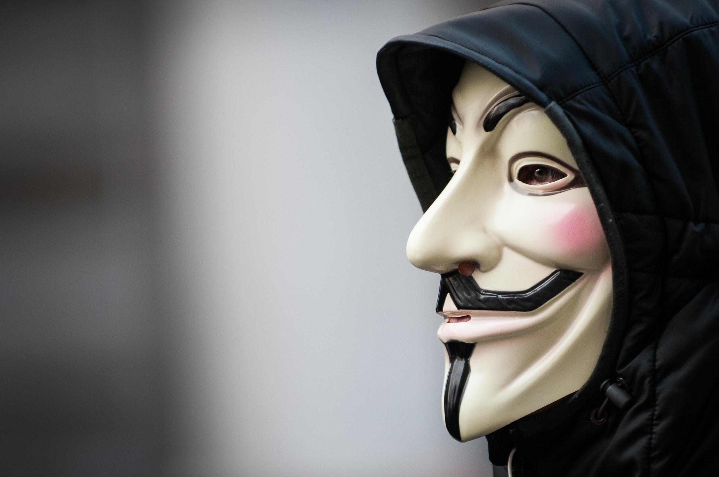Person wearing an Anonymous mask and hood HD Wallpaper