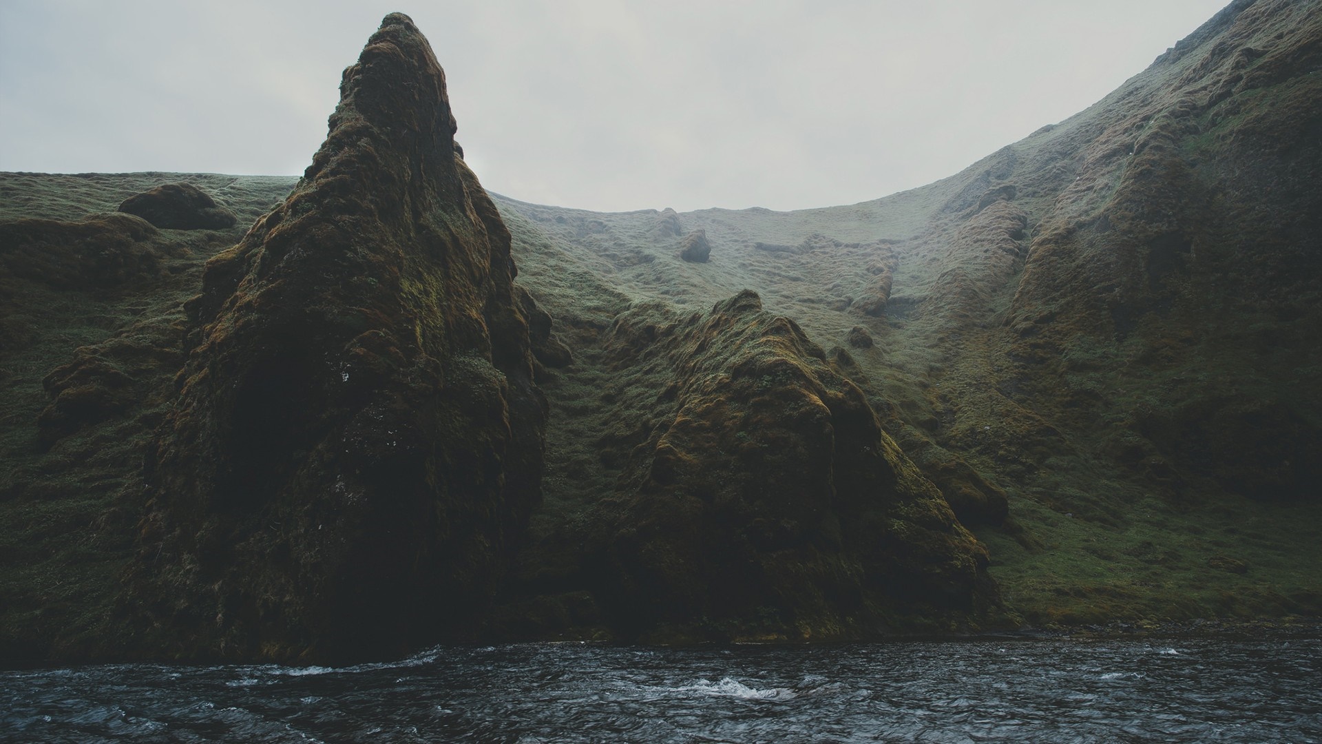 Mossy rocks and river in a misty valley HD Wallpaper