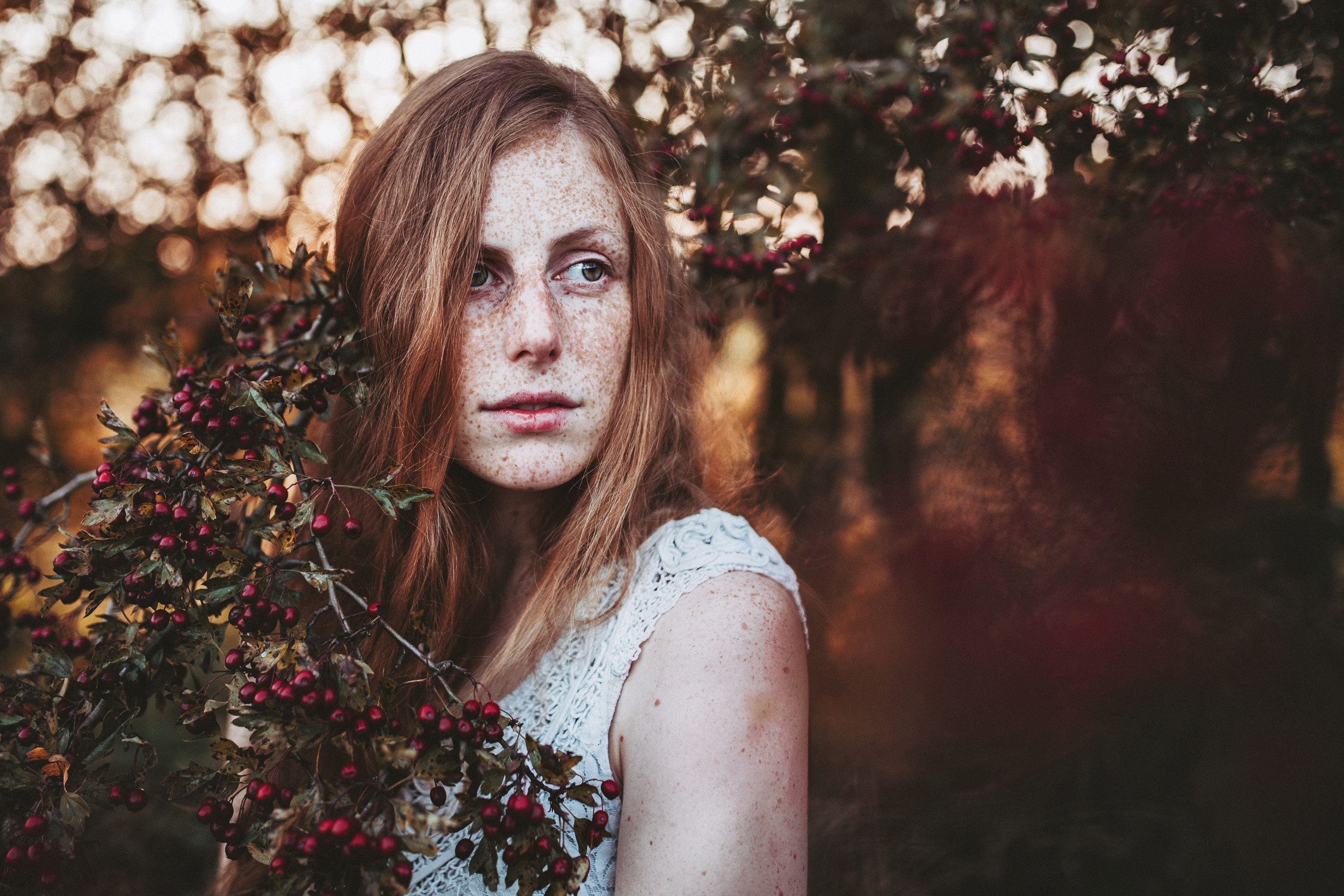 Woman with freckles and red berries HD Wallpaper