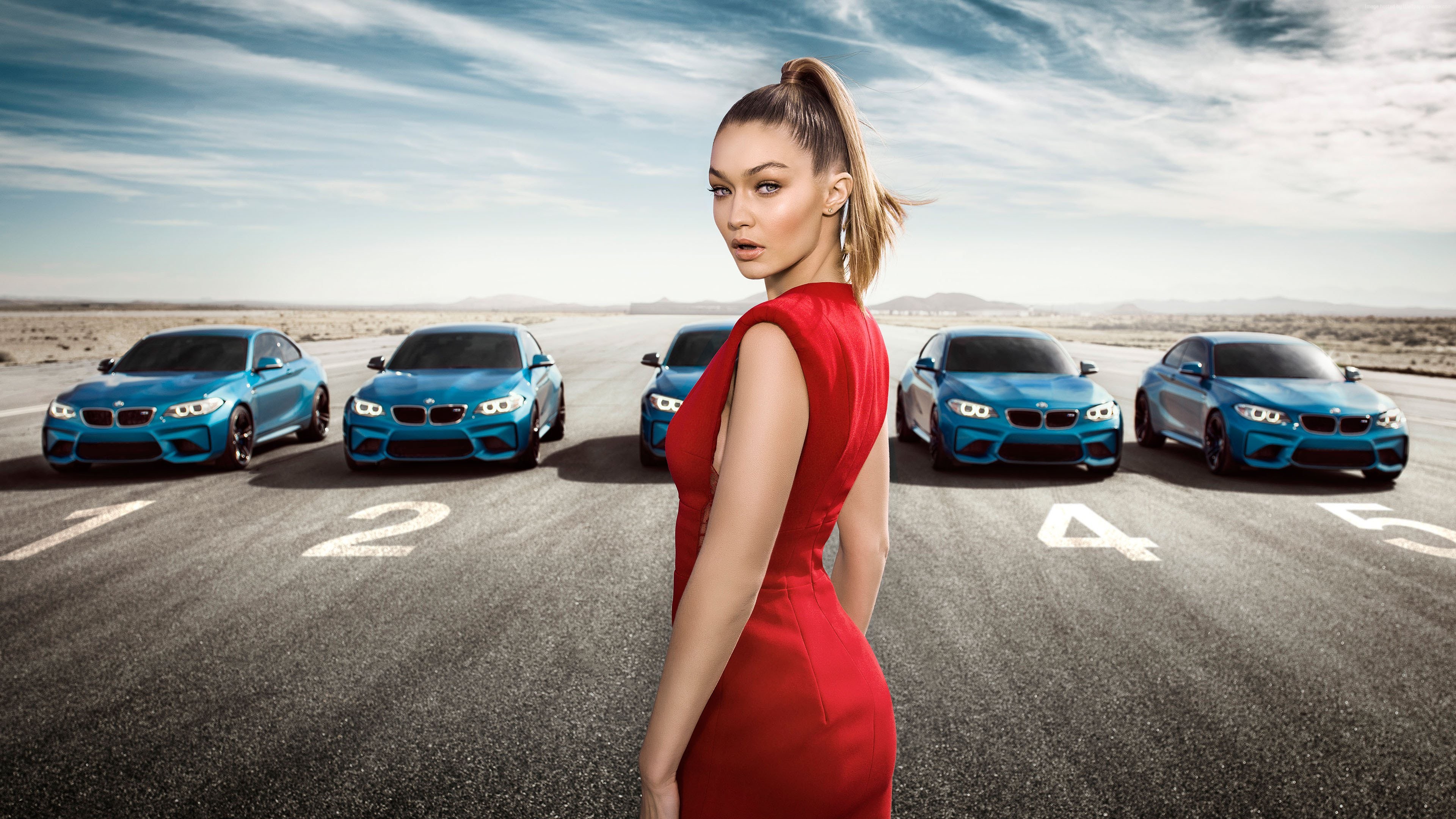 Gigi Hadid with BMW M2 Coupes on a Racetrack HD Wallpaper