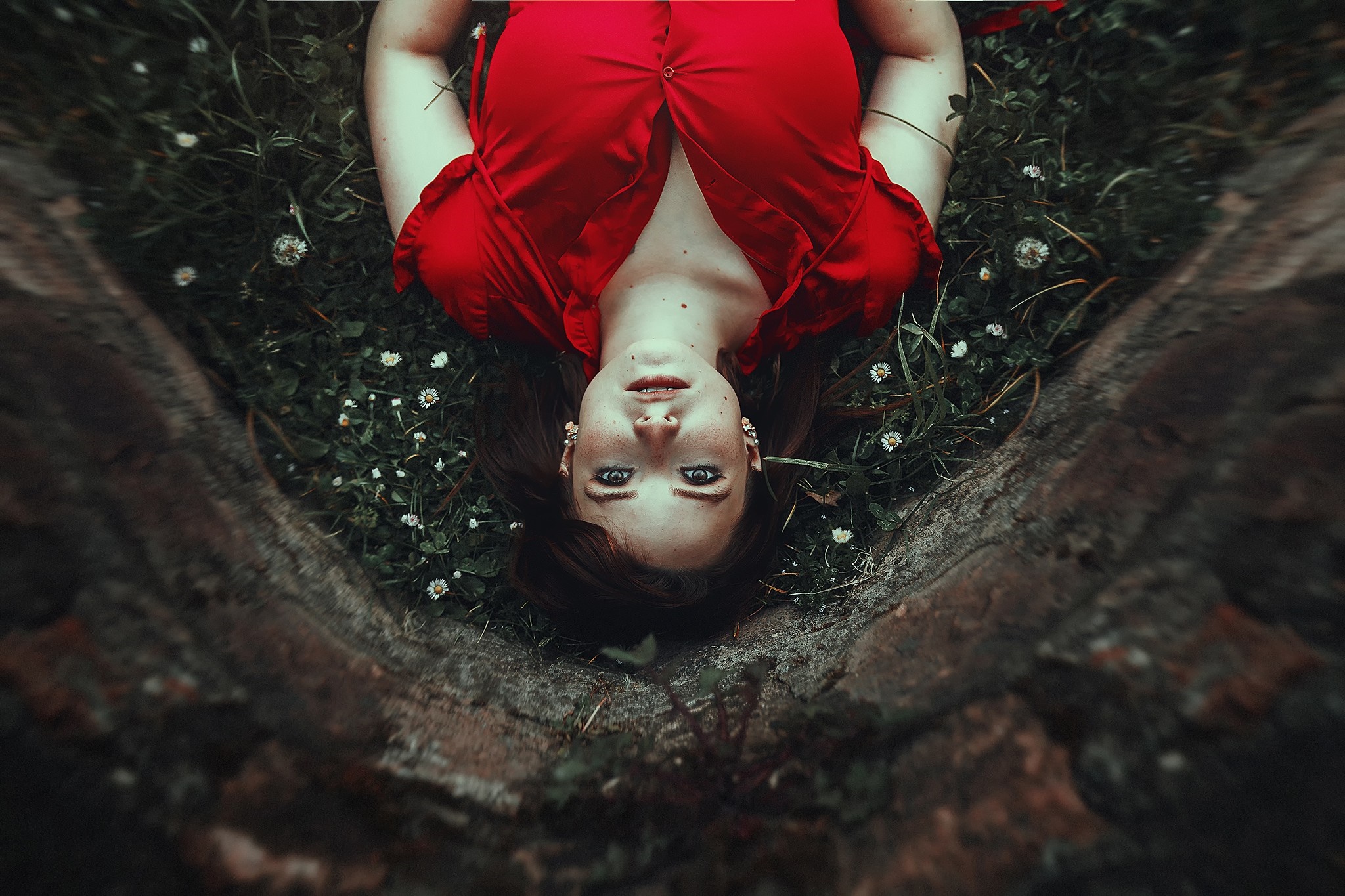 Woman in red dress lying in grass with flowers HD Wallpaper