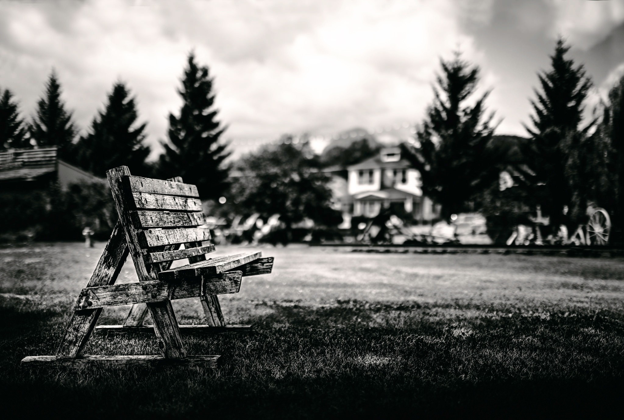 Wooden bench in front of a house and trees HD Wallpaper