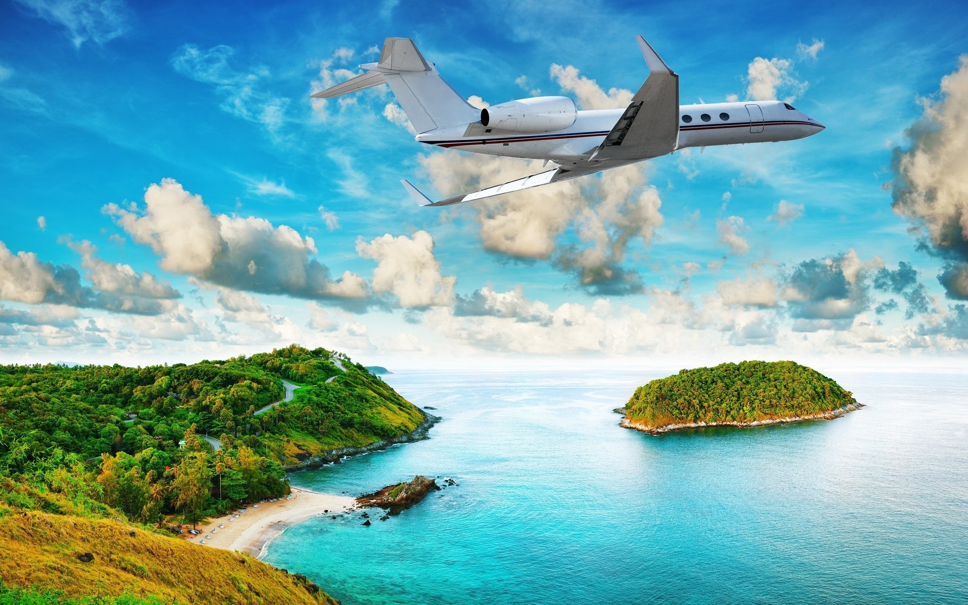 Private jet flying over tropical islands and ocean HD Wallpaper
