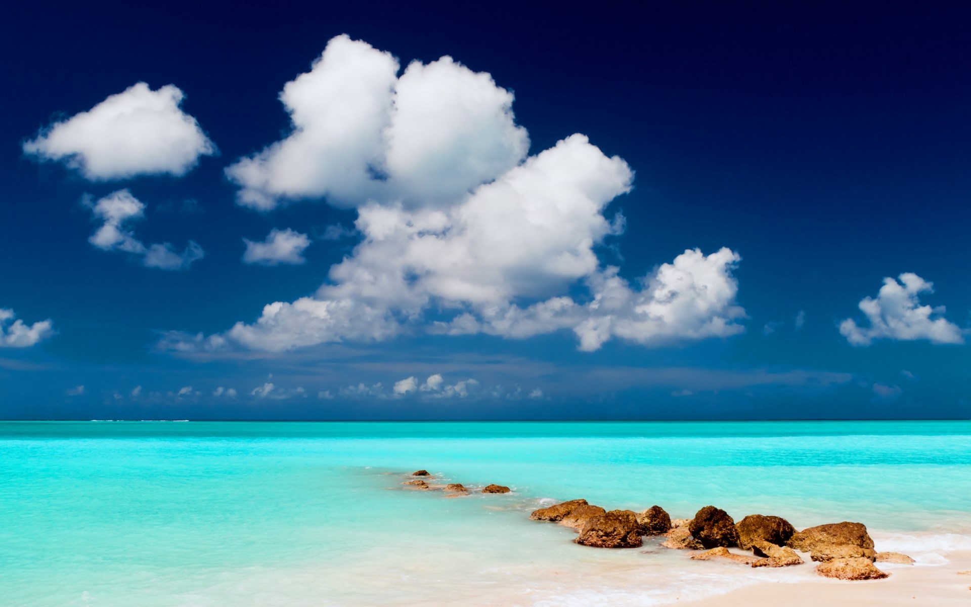 Turquoise ocean and white clouds under a blue sky HD Wallpaper