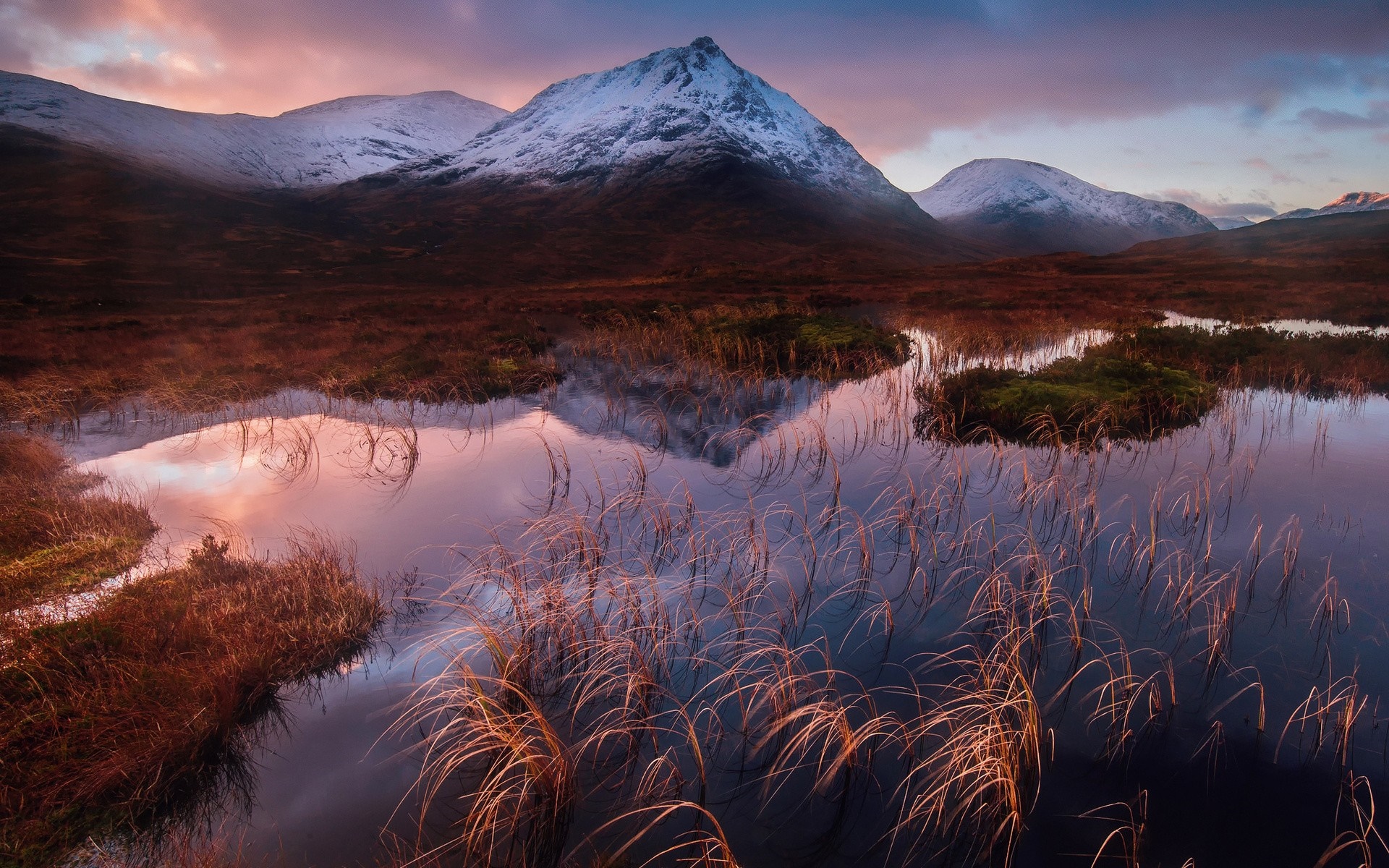 Snow-capped mountains reflected in a misty loch at sunrise HD Wallpaper