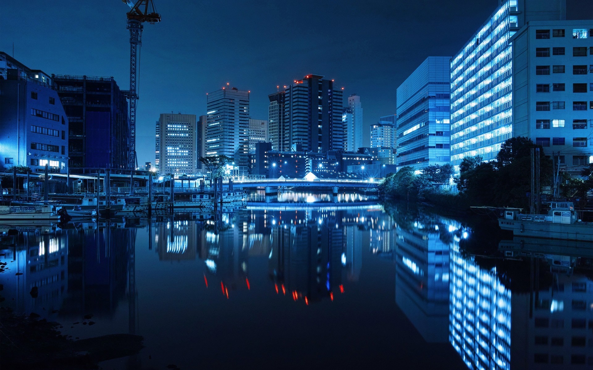 Cityscape reflection in water at night HD Wallpaper