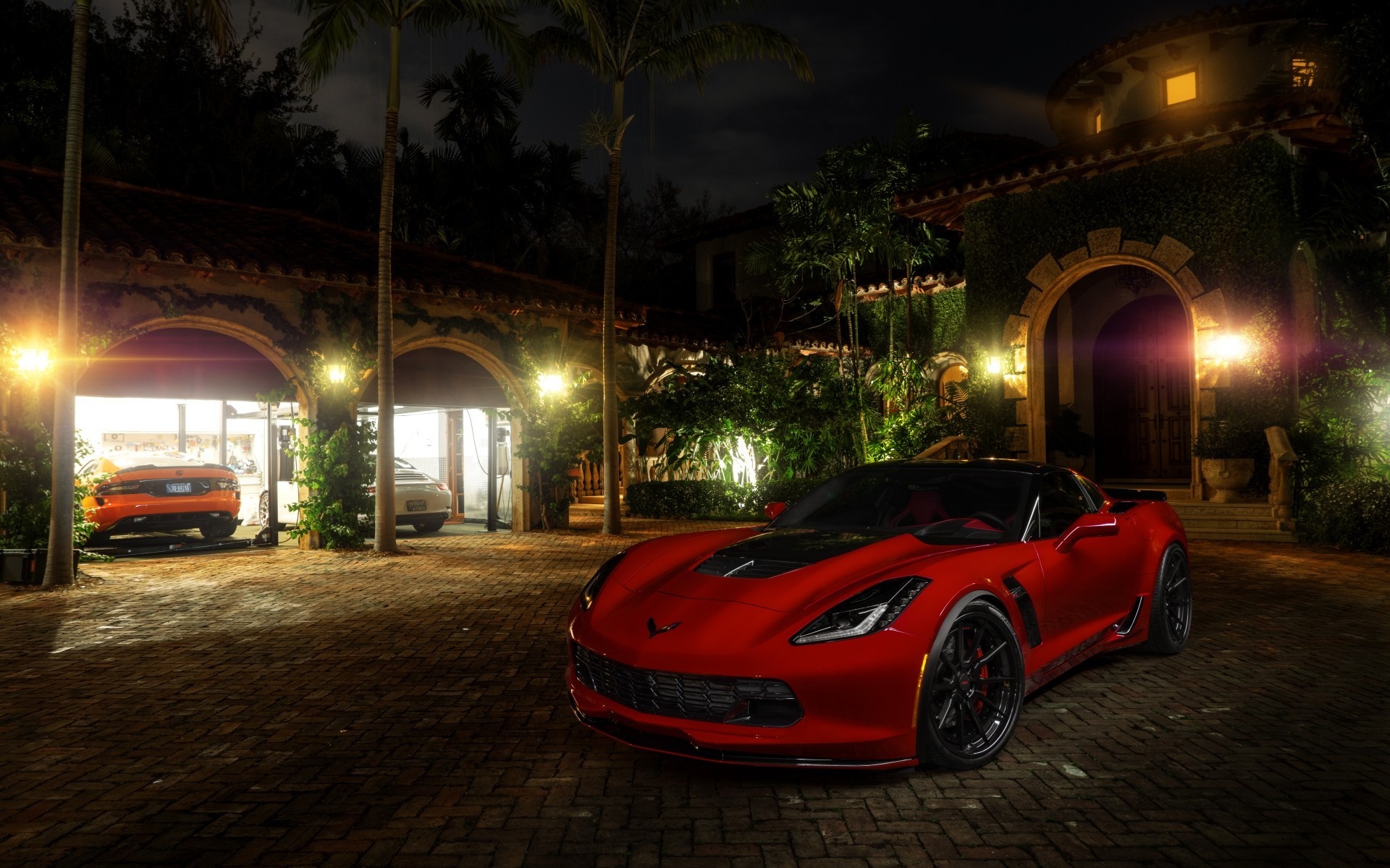 Red Chevrolet Corvette parked in front of a mansion at night HD Wallpaper