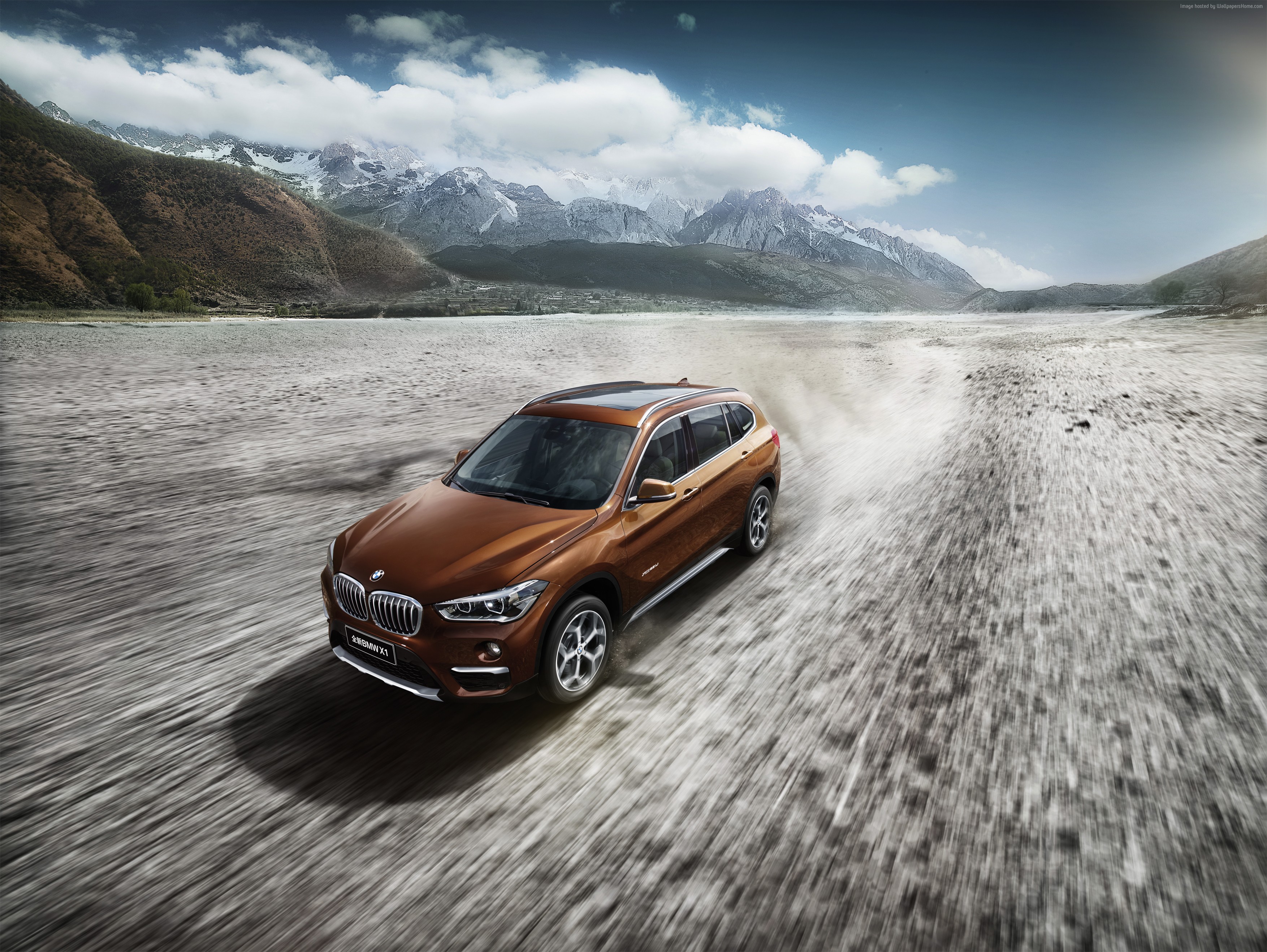 BMW X1 xDrive25i xLine driving on a dirt road HD Wallpaper