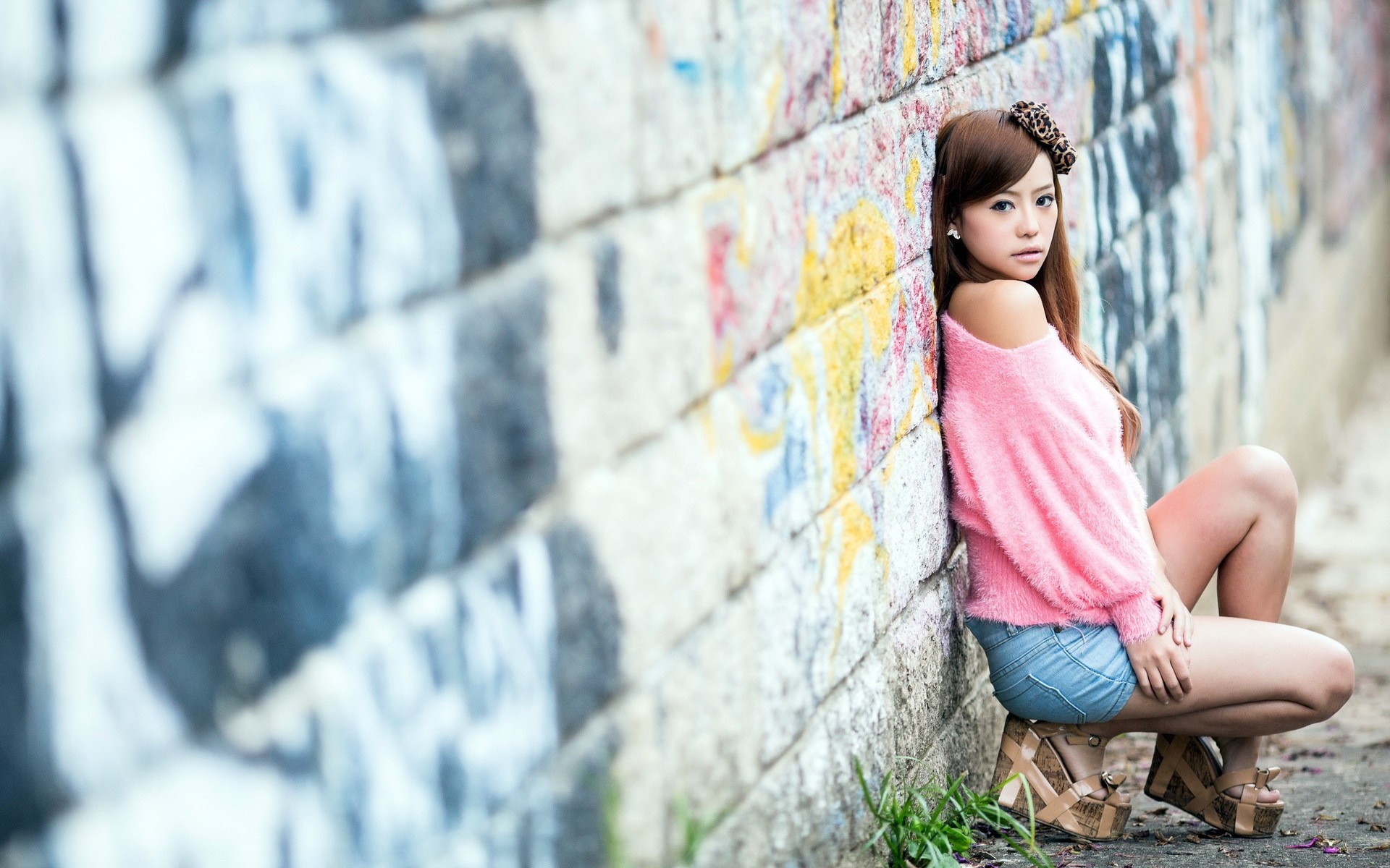Asian woman posing against a graffiti wall HD Wallpaper