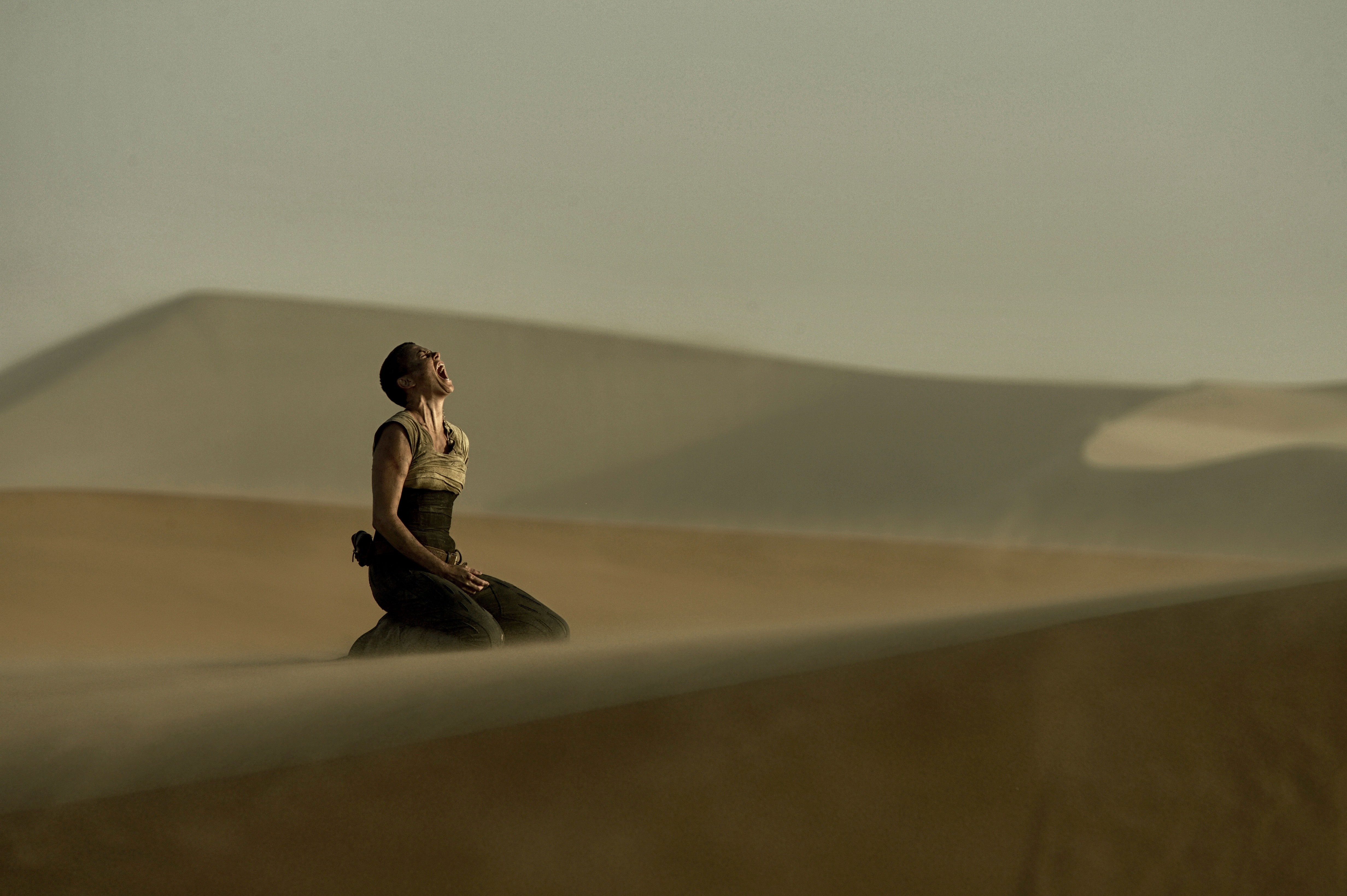 Furiosa from Mad Max: Fury Road screaming in the desert HD Wallpaper